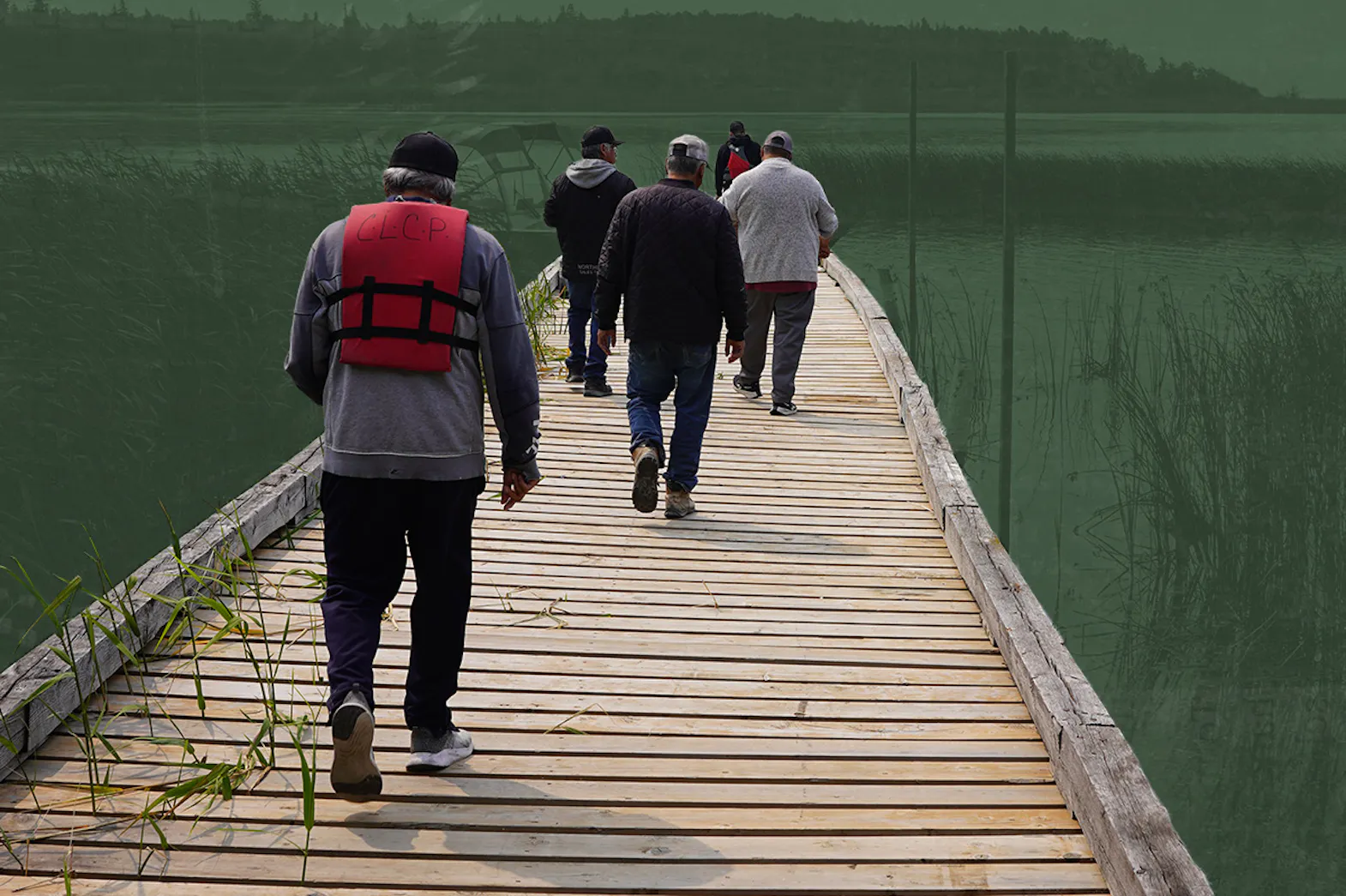 People walking on a dock wearing life jackets. A lake and hills are in the horizon.