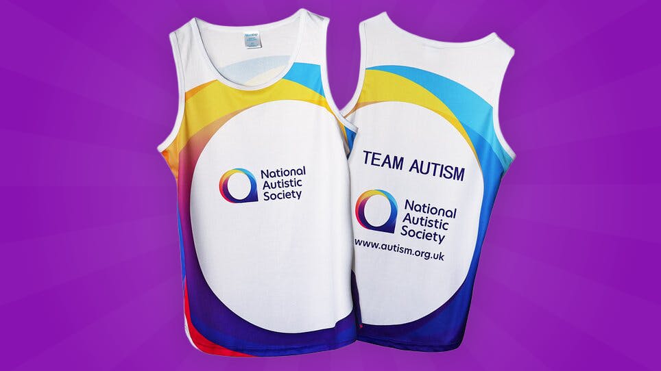 Two white vests with colorful accents and National Autistic Society logo; one reads ‘TEAM AUTISM’ with website.