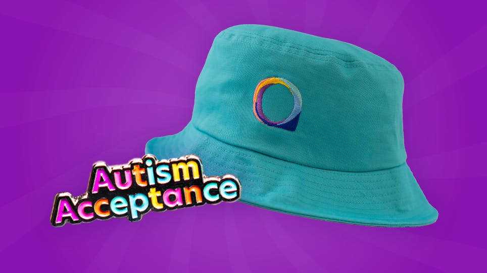 Turquoise bucket hat with National Autistic Society logo, next to colourful text reading ‘Autism Acceptance’ on a purple background.