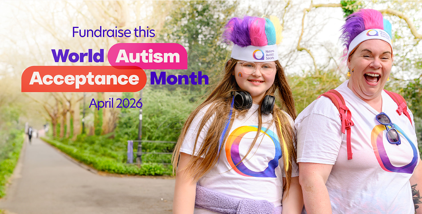 Two people smile for the camera on a path in a park. Both wear matching t-shirts and colourful, fluffy headbands. Text overlay reads, 'Fundraise this World Autism Acceptance Month April 2026