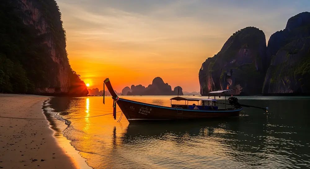 Single longtail boat silhouetted against sunset