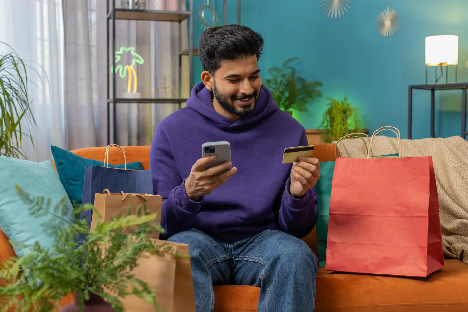 A Meesho customer shopping online using a phone and credit card.