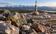 Gold-Flecked Ore Beneath Mountain Rigs