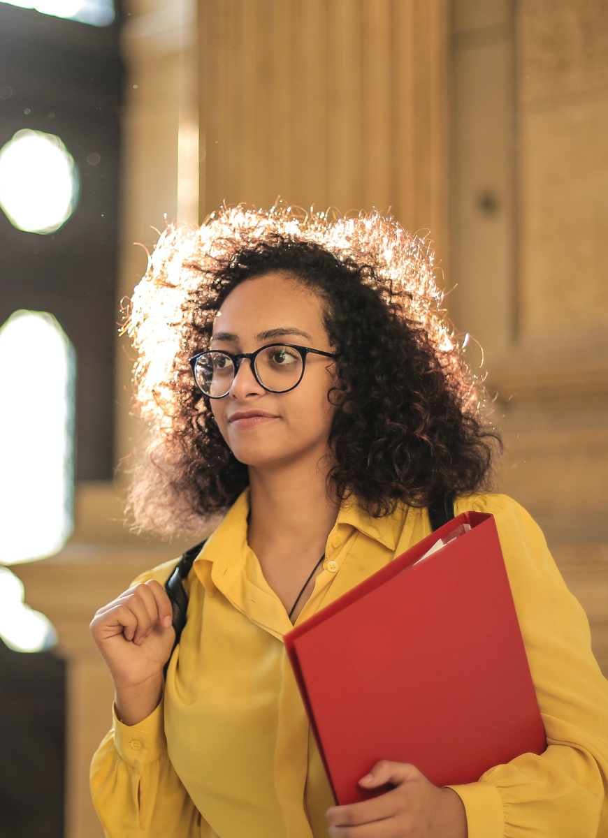 Student walking with file in hand