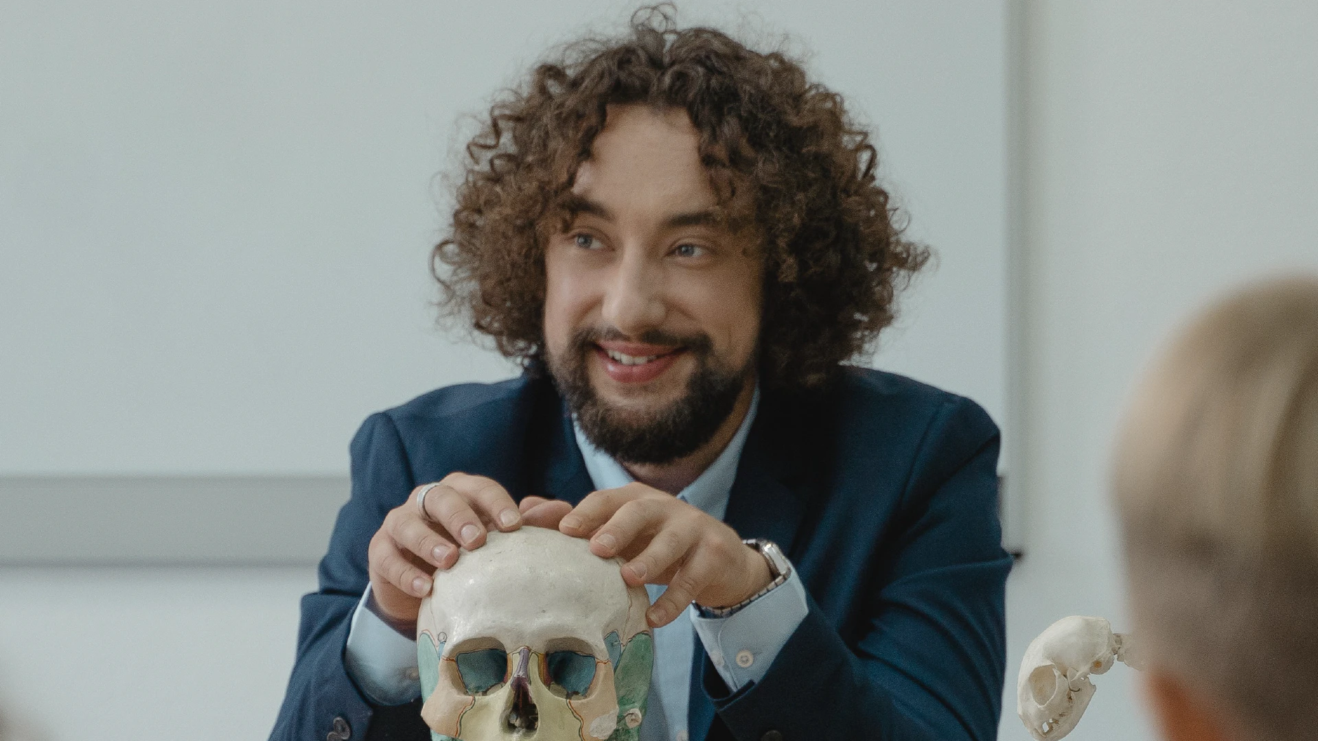 a photo of a student holding a skull during class at QUB