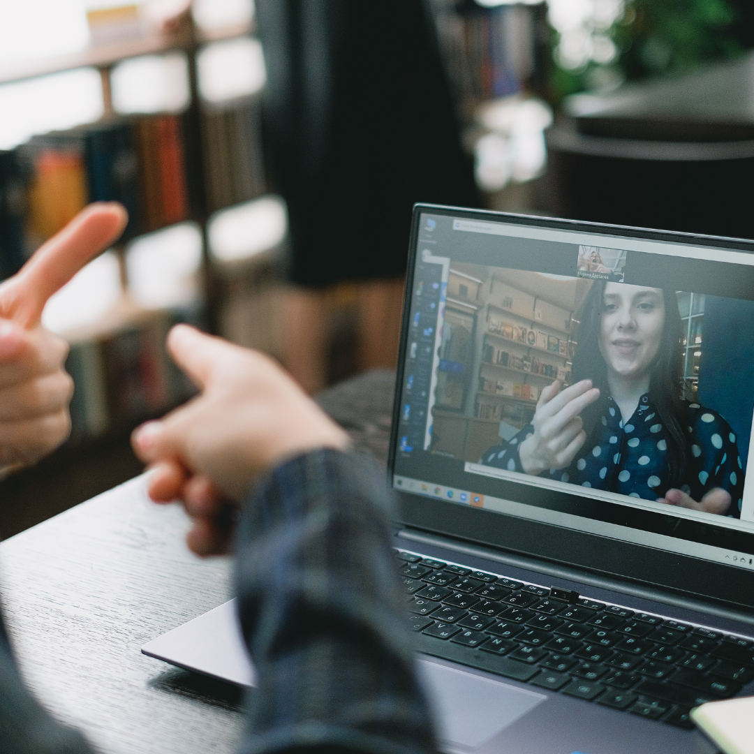 Student learning sign language during online lesson with female tutor