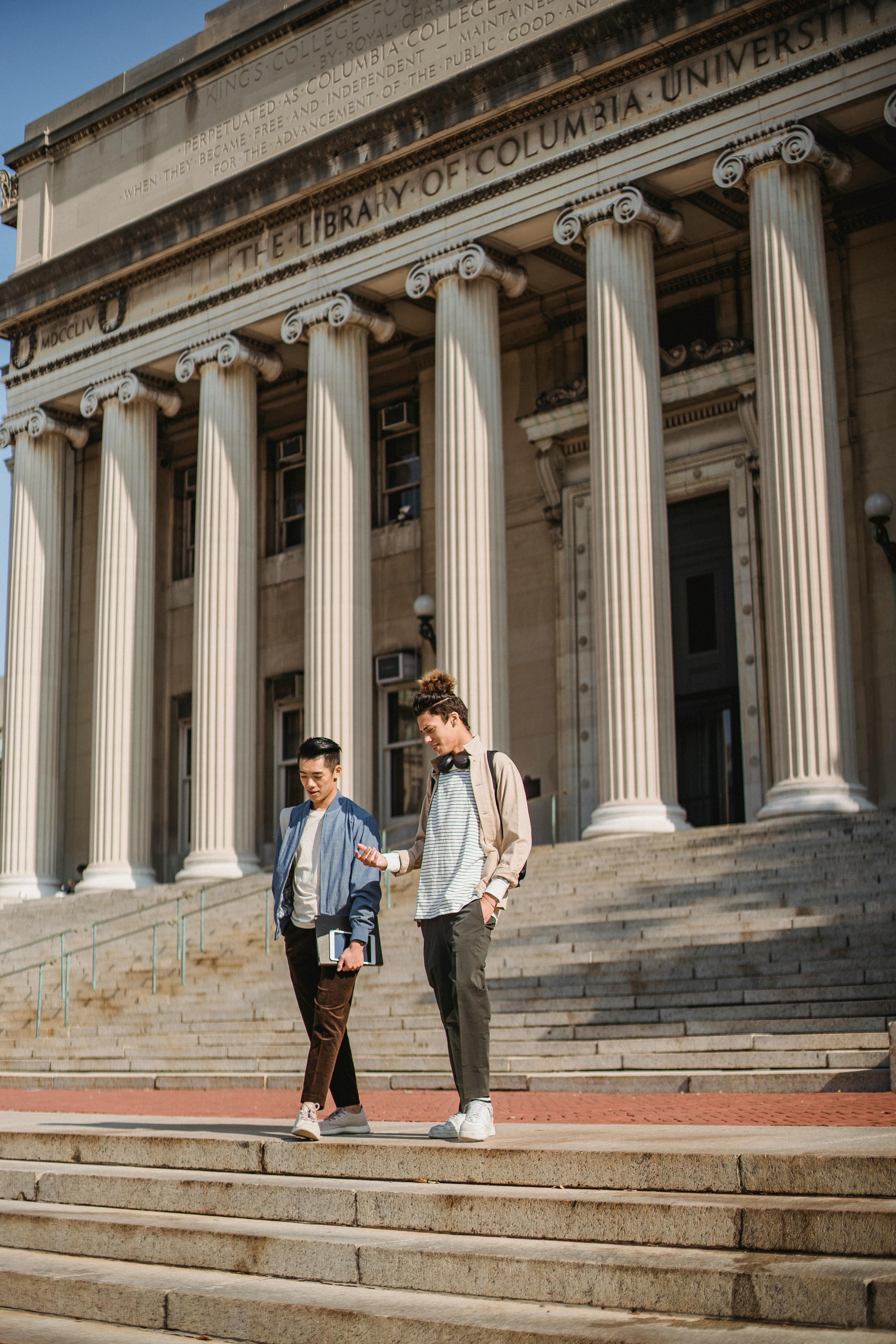 Two students walking down stairs at Columbia University