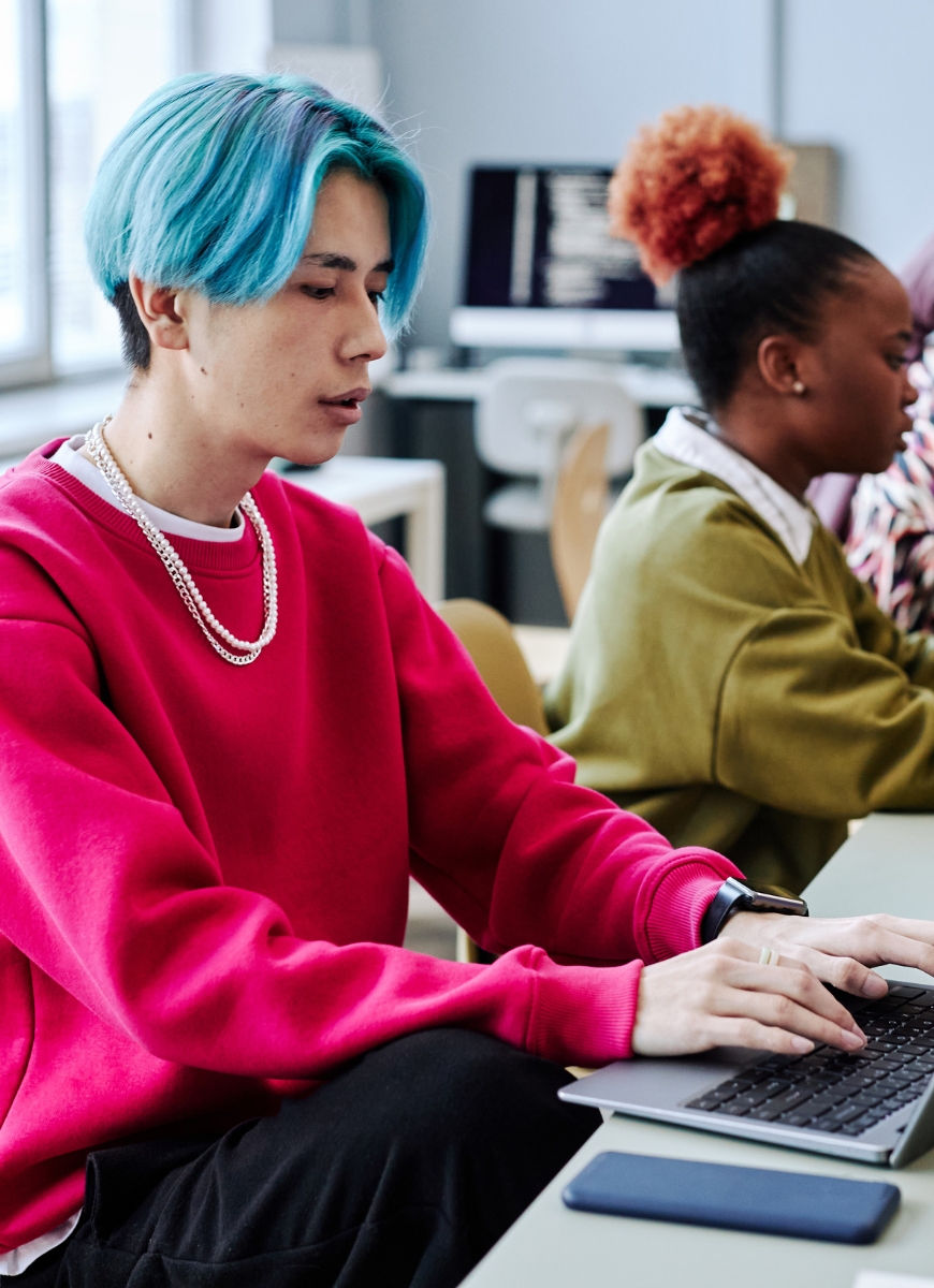 Two students on laptops studying