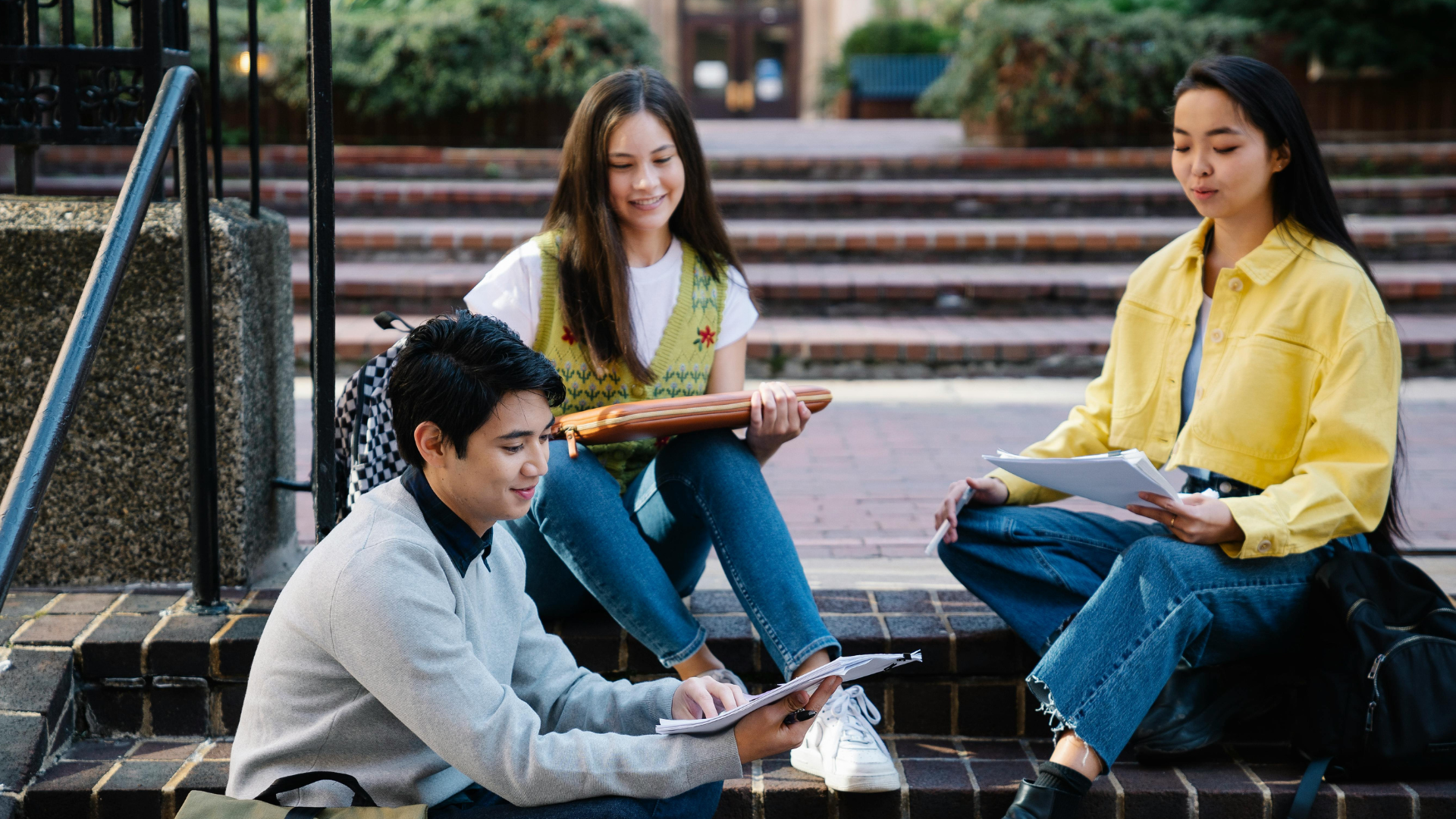 Students sat on steps studying 