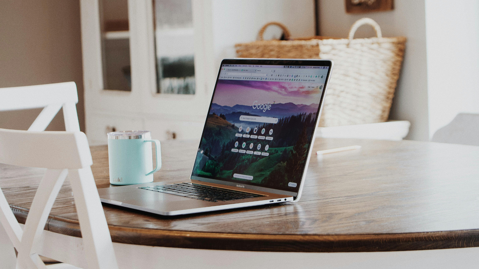 laptop open on table with google page open