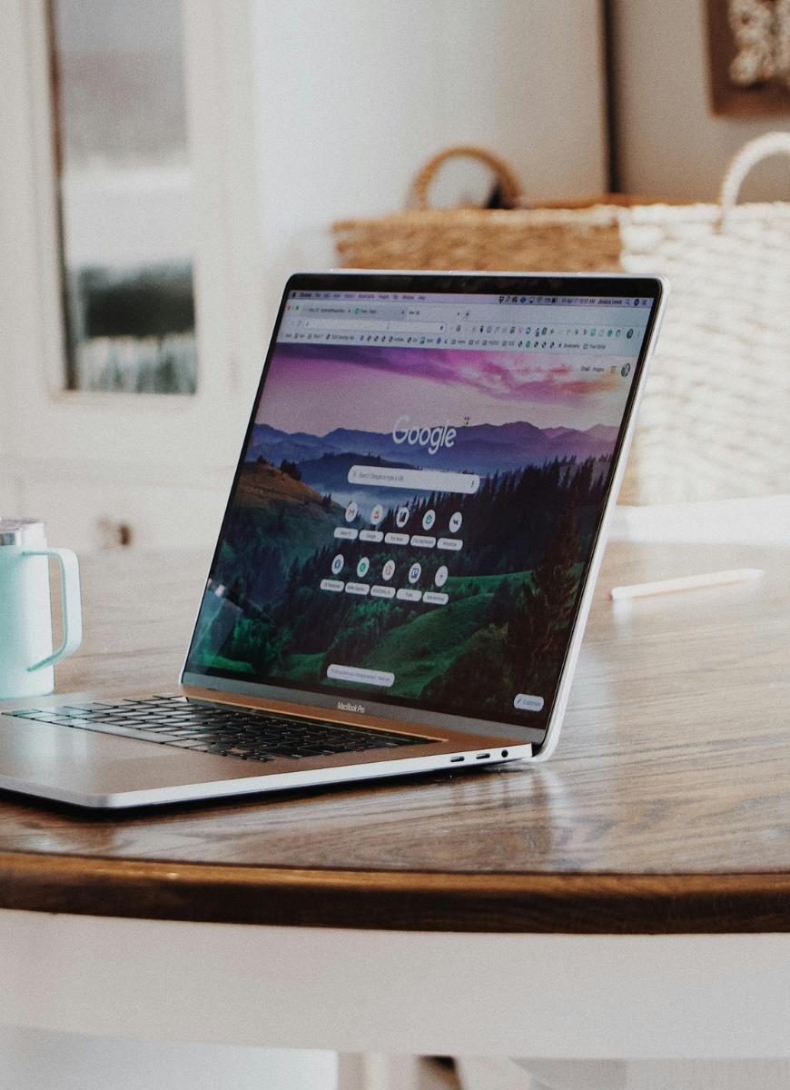 laptop open on table with google page open