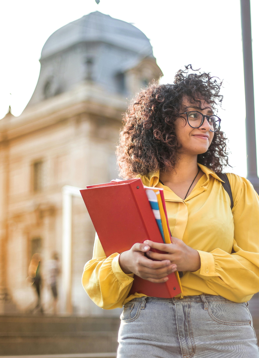 student walking down steps holding folders