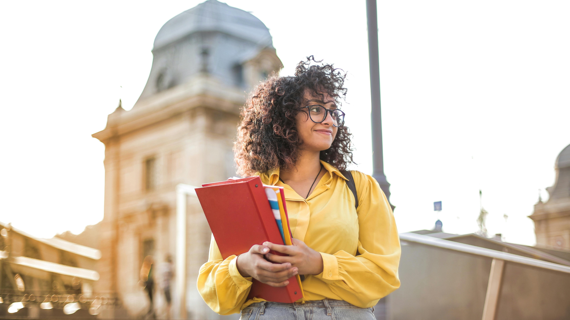 student walking down steps holding folders