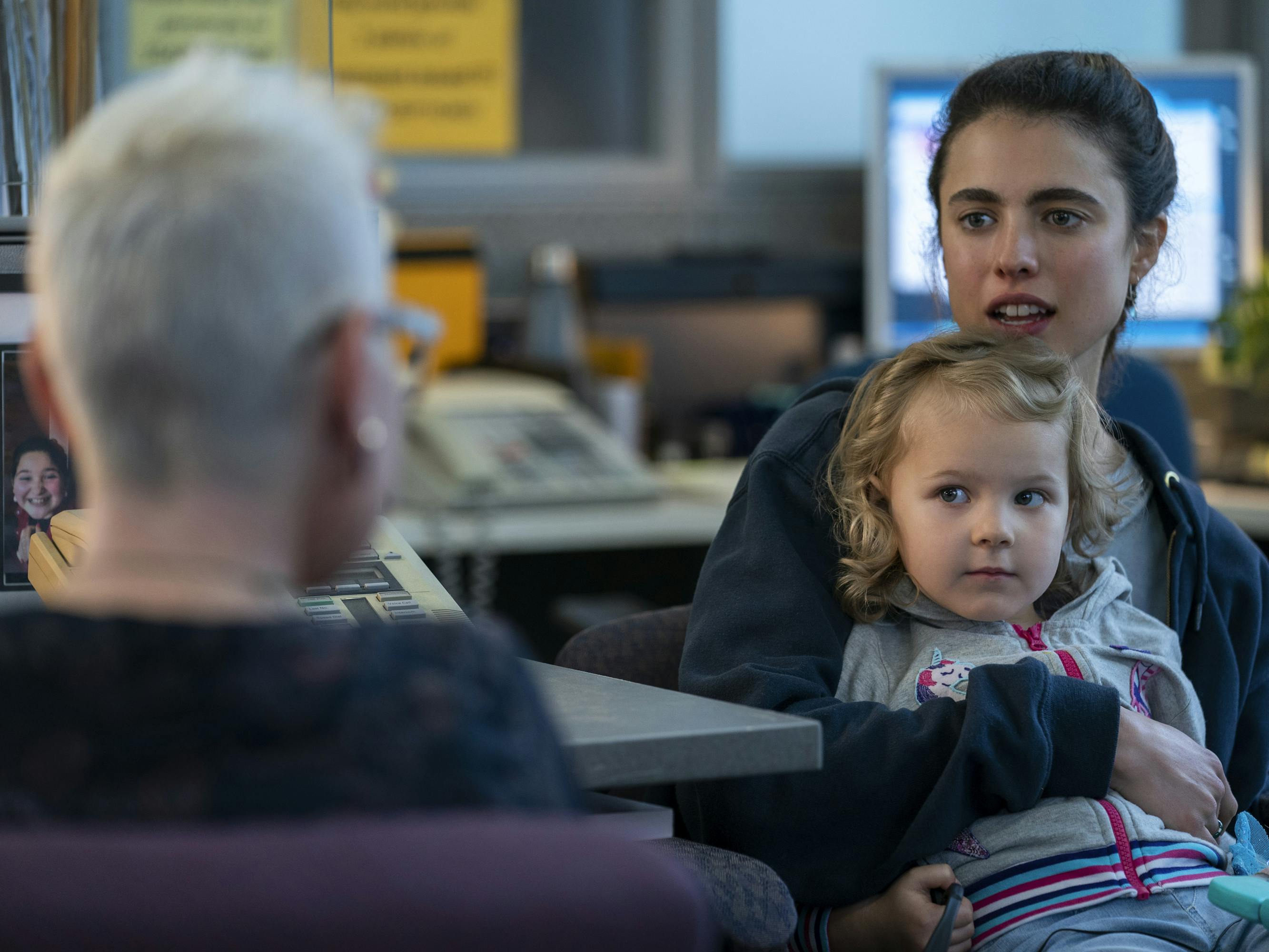 Maddy (Rylea Nevaeh Whittet) and Alex Russell (Margaret Qualley) talk to a person with short white hair in an office. Russell looks stressed and Maddy looks adorable, as per usual.