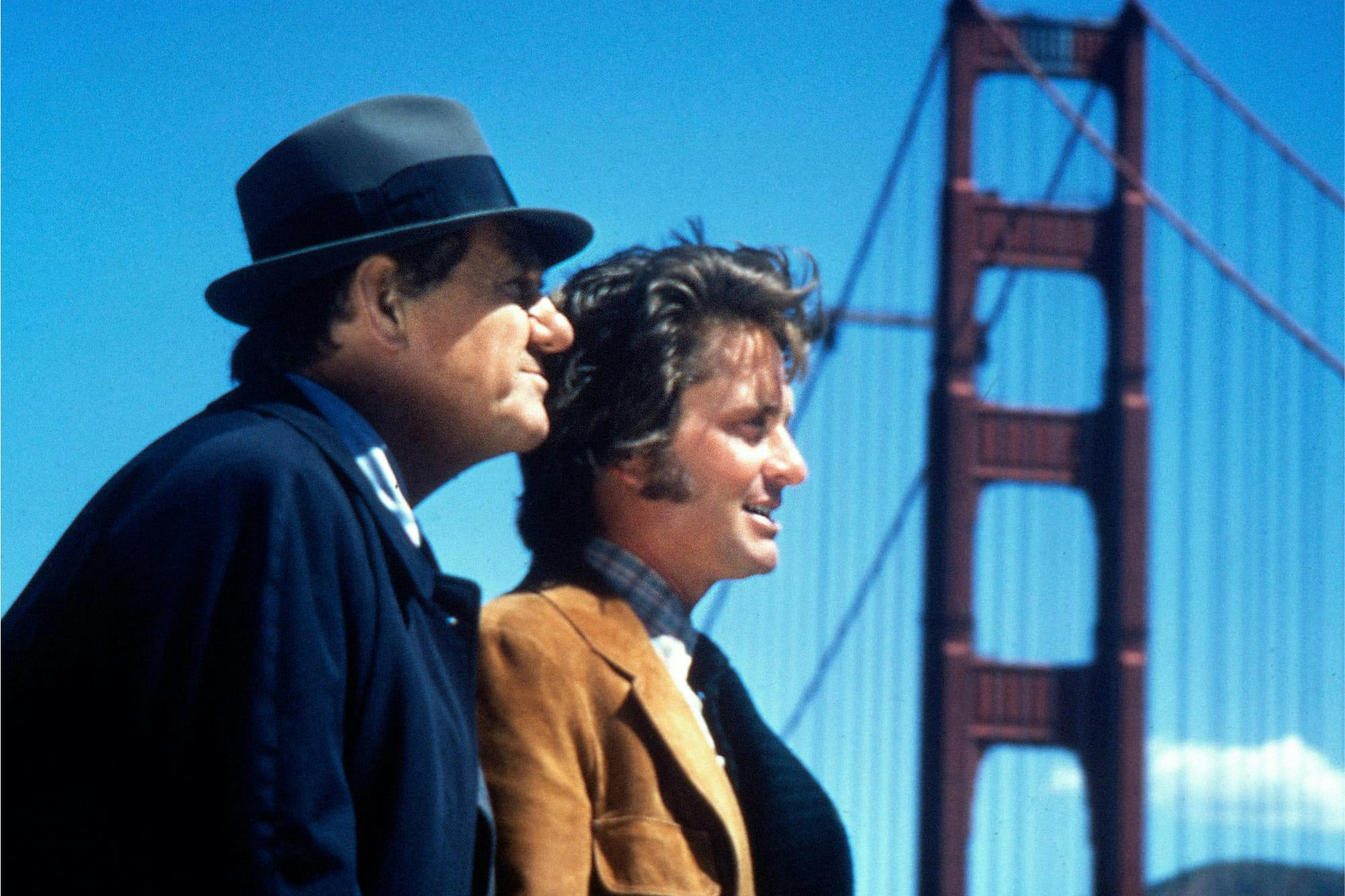 Detective Lieutenant Mike Stone (Karl Madden) and Inspector Steve Keller (Michael Douglas) in The Streets of San Francisco stand by the Golden Gate Bridge, looking out on the water.