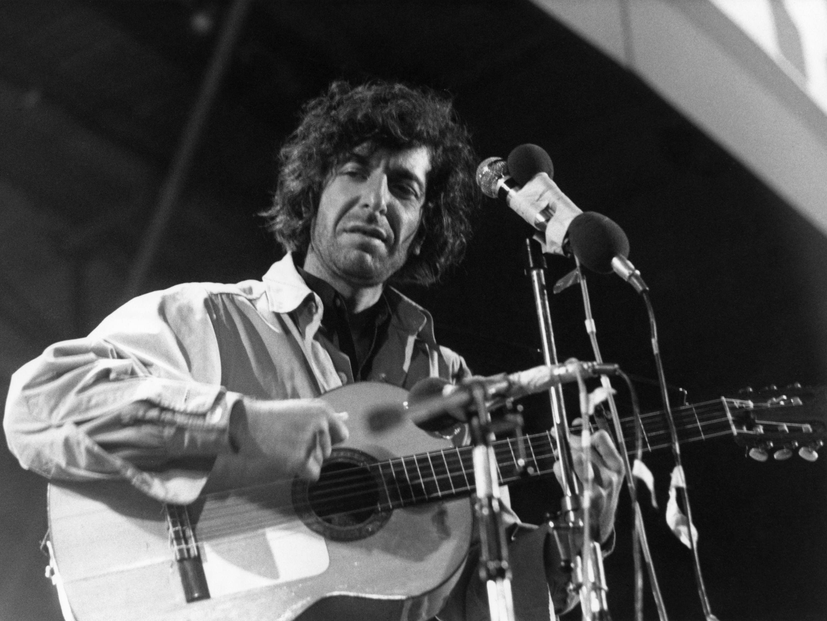 Leonard Cohen plays the guitar and looks angsty.