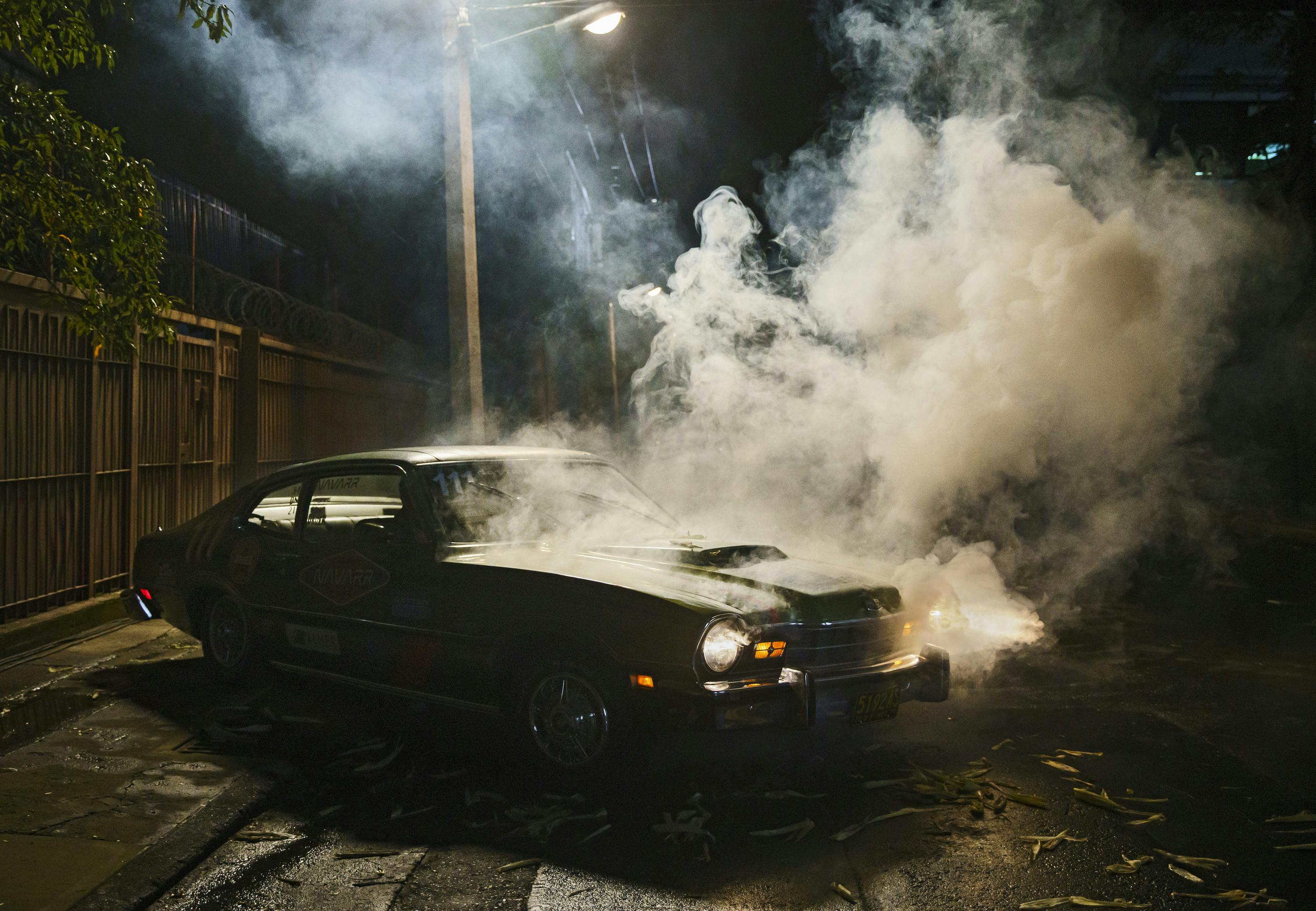 A smoking car in the dark.