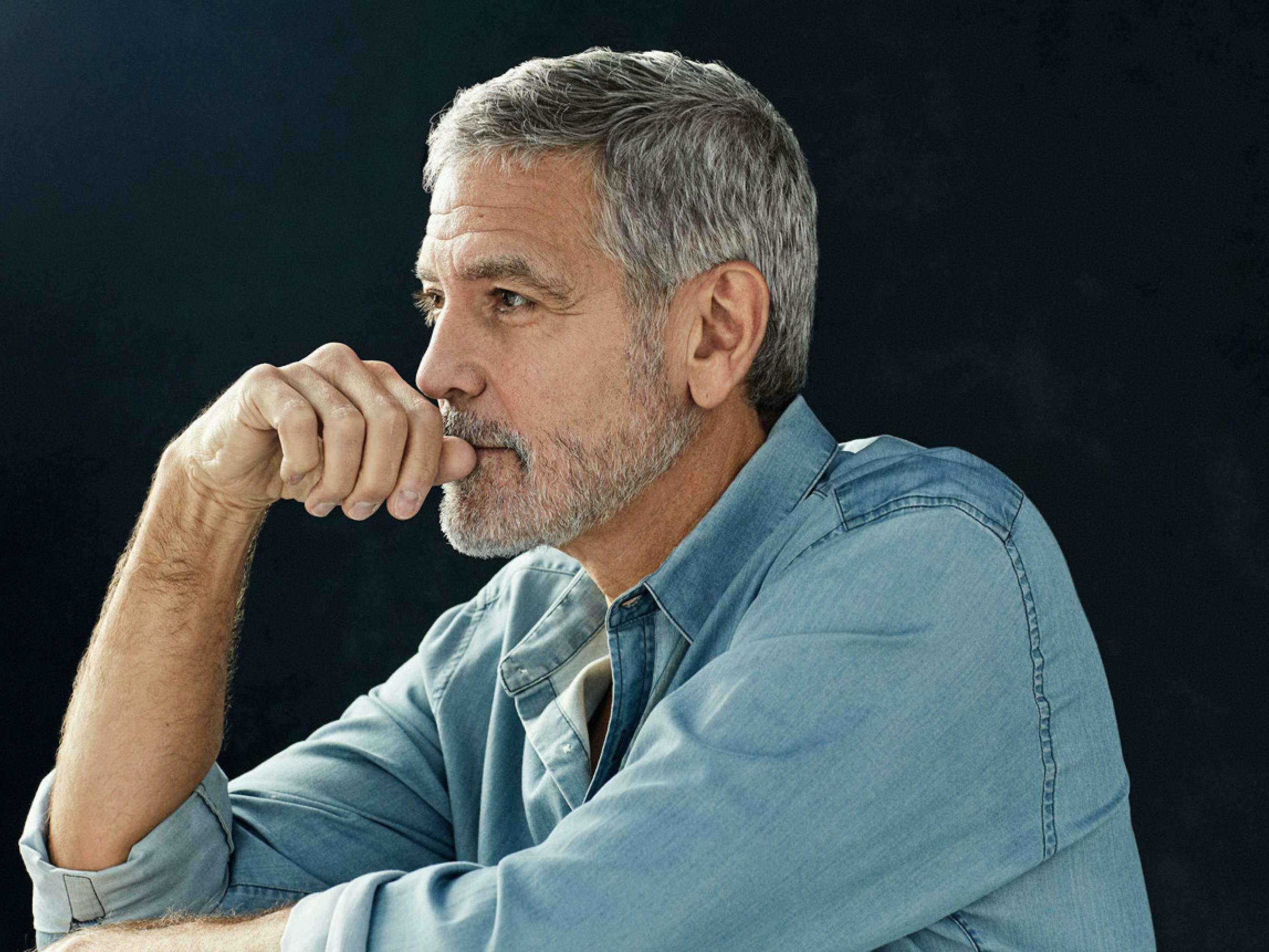 George Clooney looking pensive against a black background. Don’t you ever wonder if he’s thinking of you?