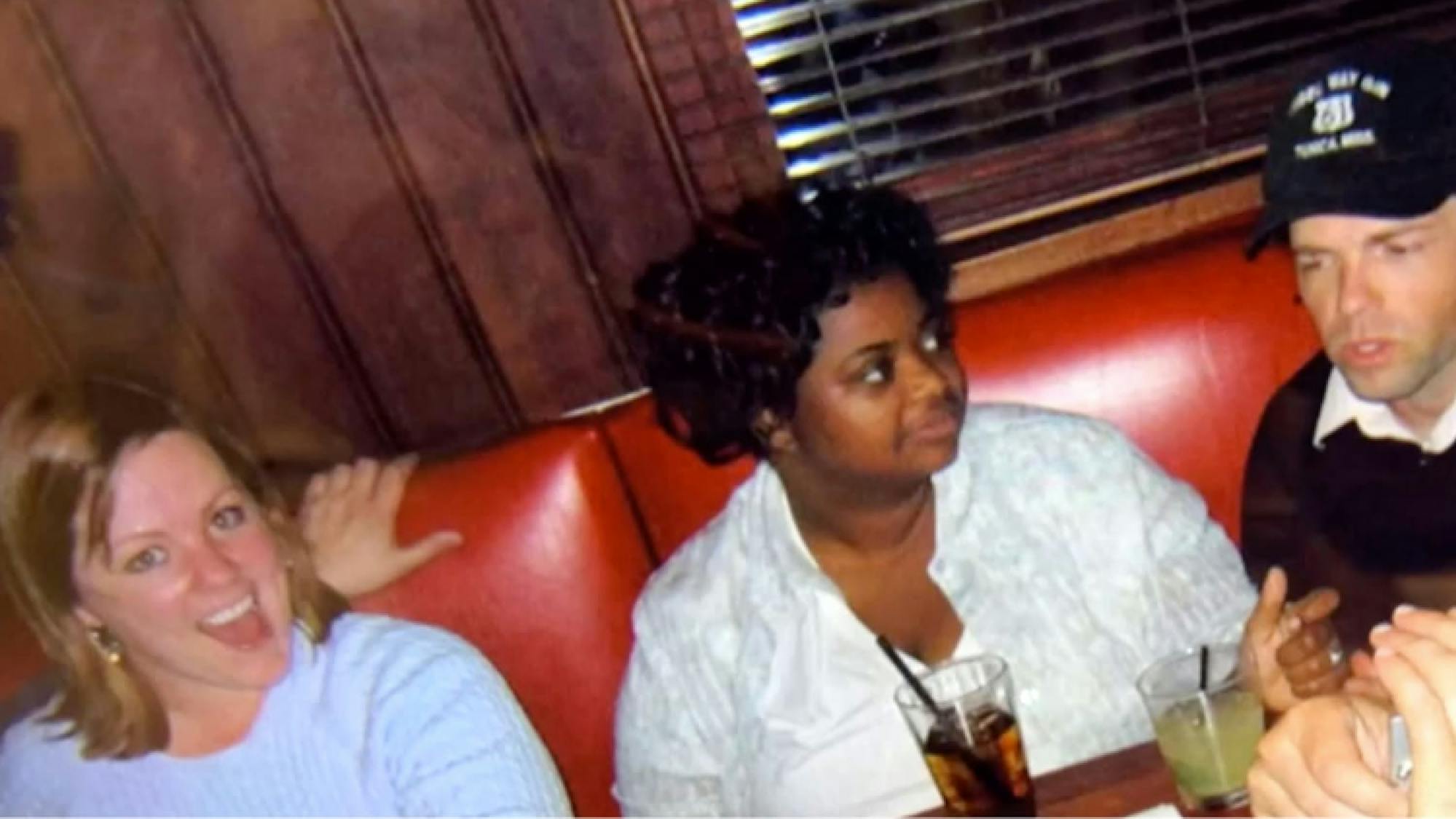 A picture from the early days of Melissa McCarthy and Octavia Spencer’s friendship. They both look young, and sit in a red booth of a restaurant. Melissa smiles at the camera while Octavia seems not to know the picture is being taken and looks elsewhere.