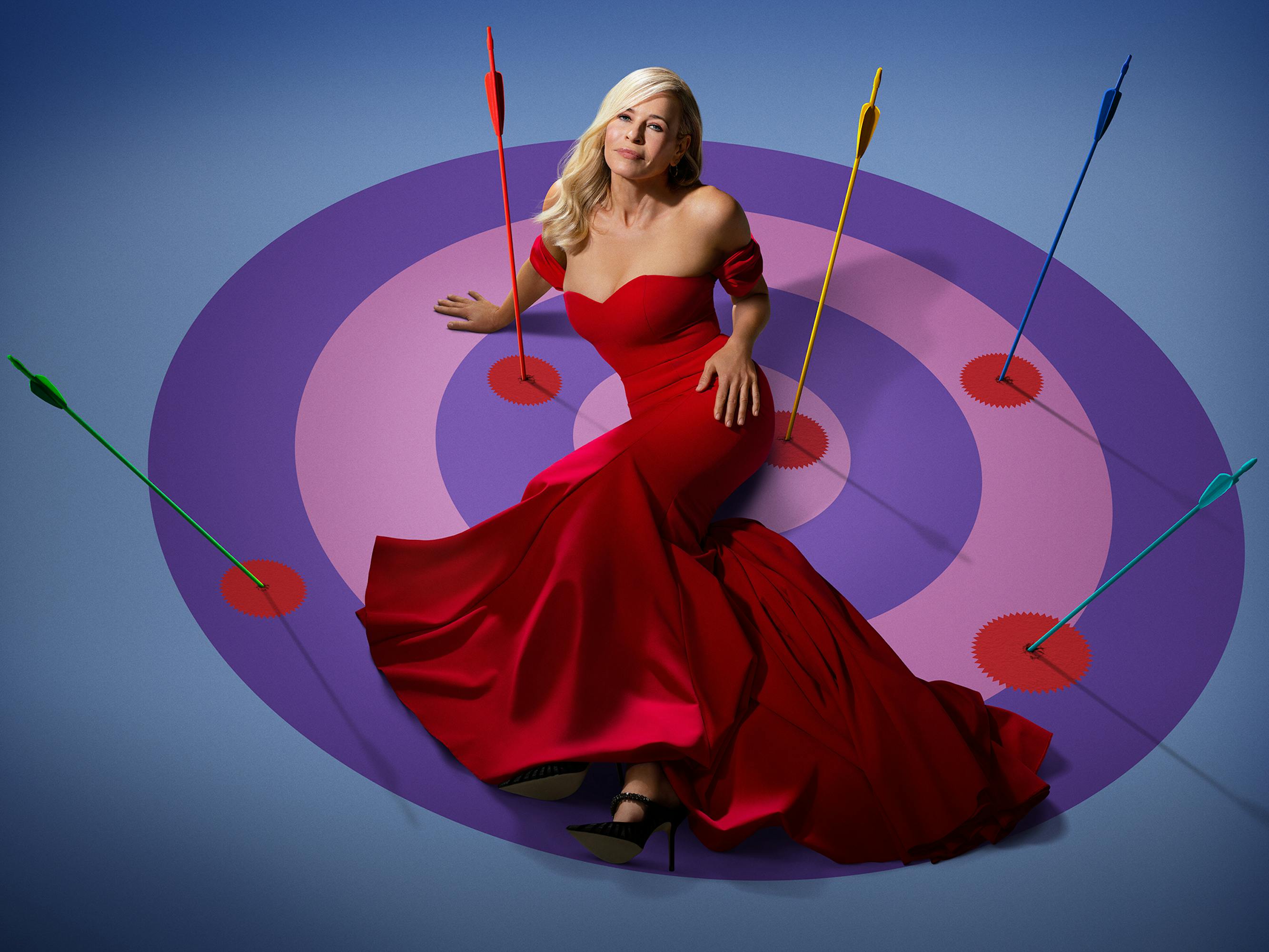 Chelsea Handler wears a red dress and lies against a bullseye.