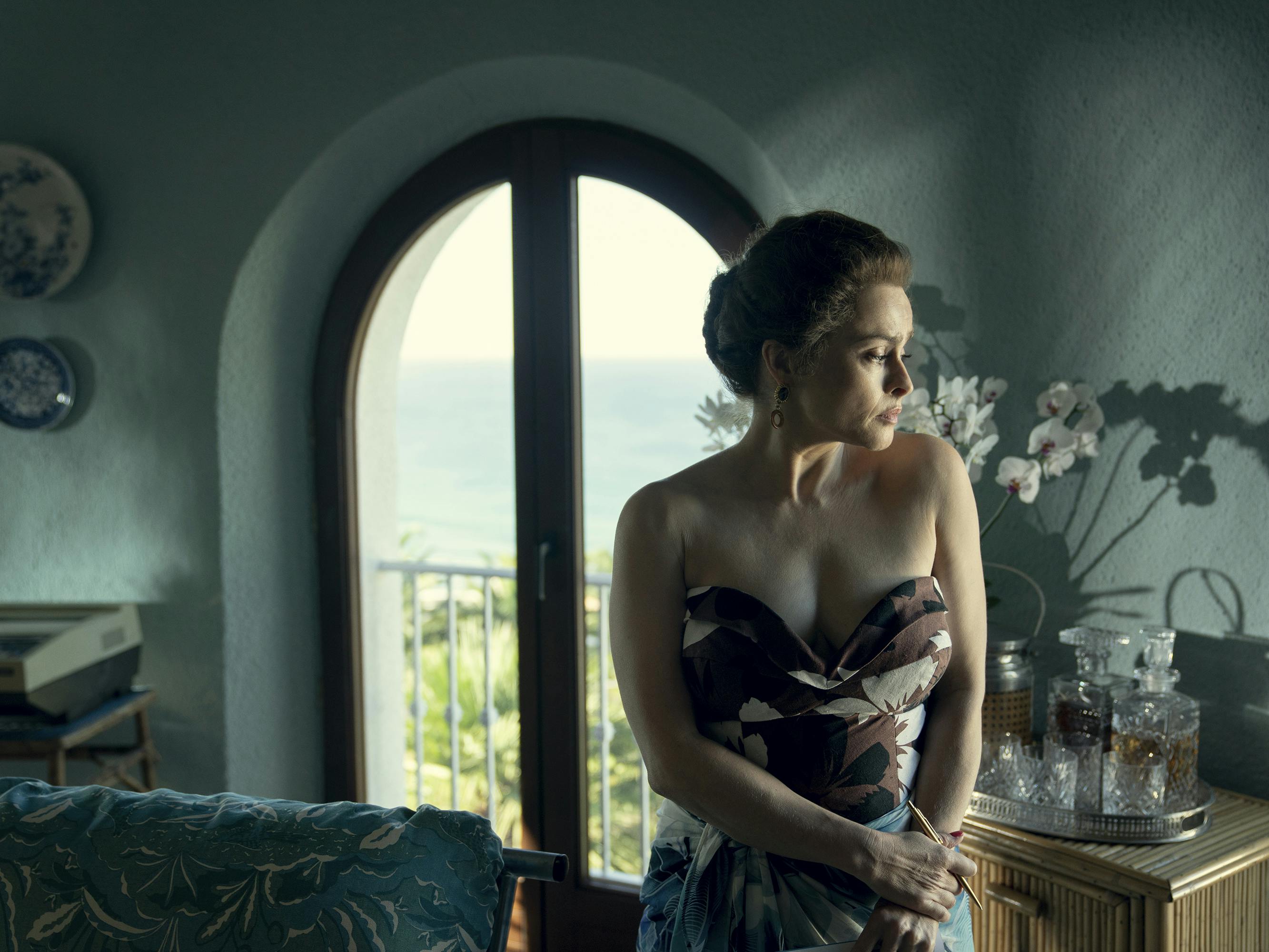 Princess Margaret (Helena Bonham Carter) wears a strapless dress in a vacation home.