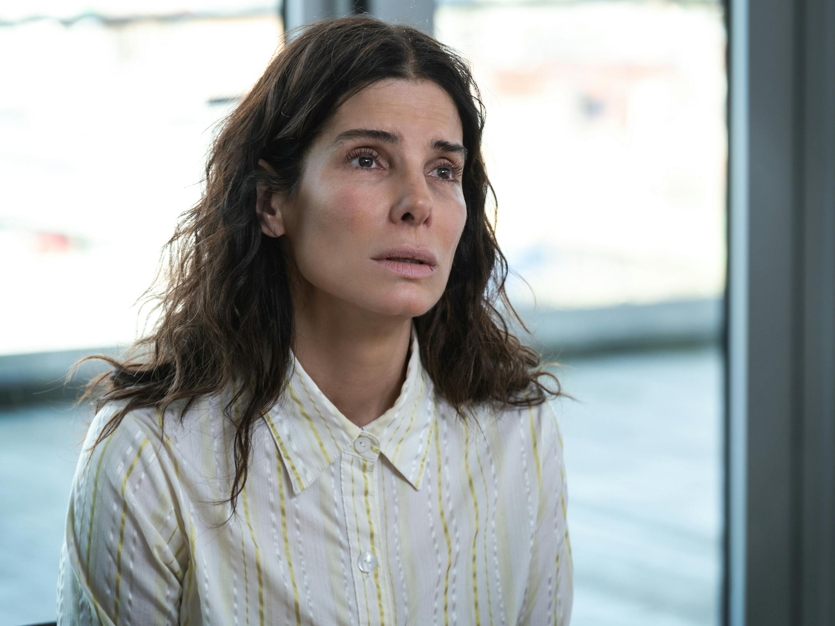 Ruth Slater (Sandra Bullock) wears a white blouse and looks pleadingly at someone offscreen. 