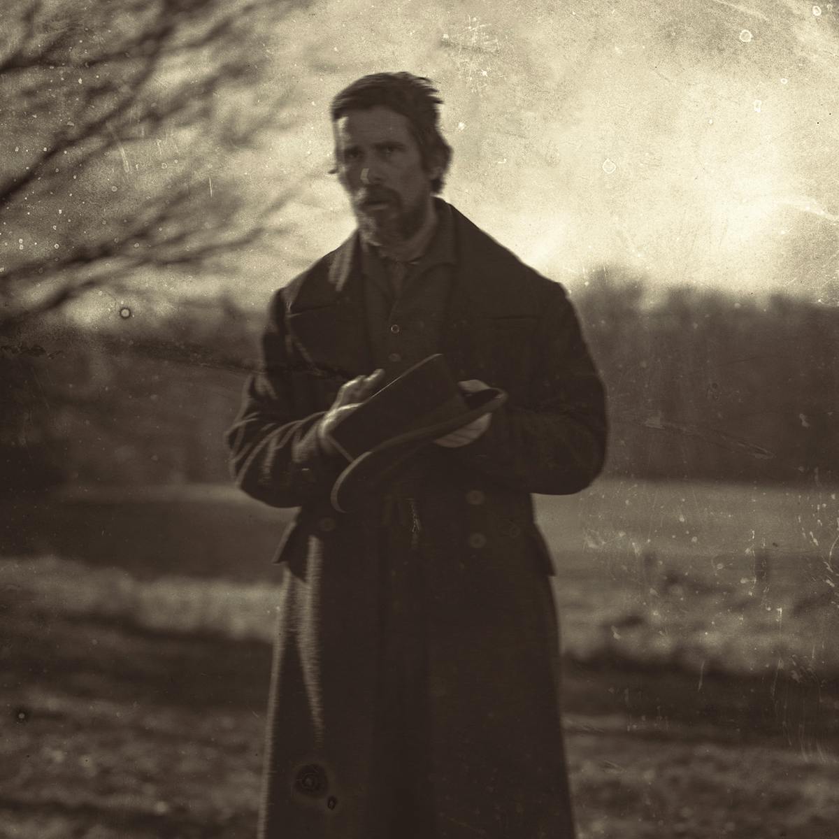 Augustus Landor (Christian Bale) wears a long coat in this sepia-toned picture.