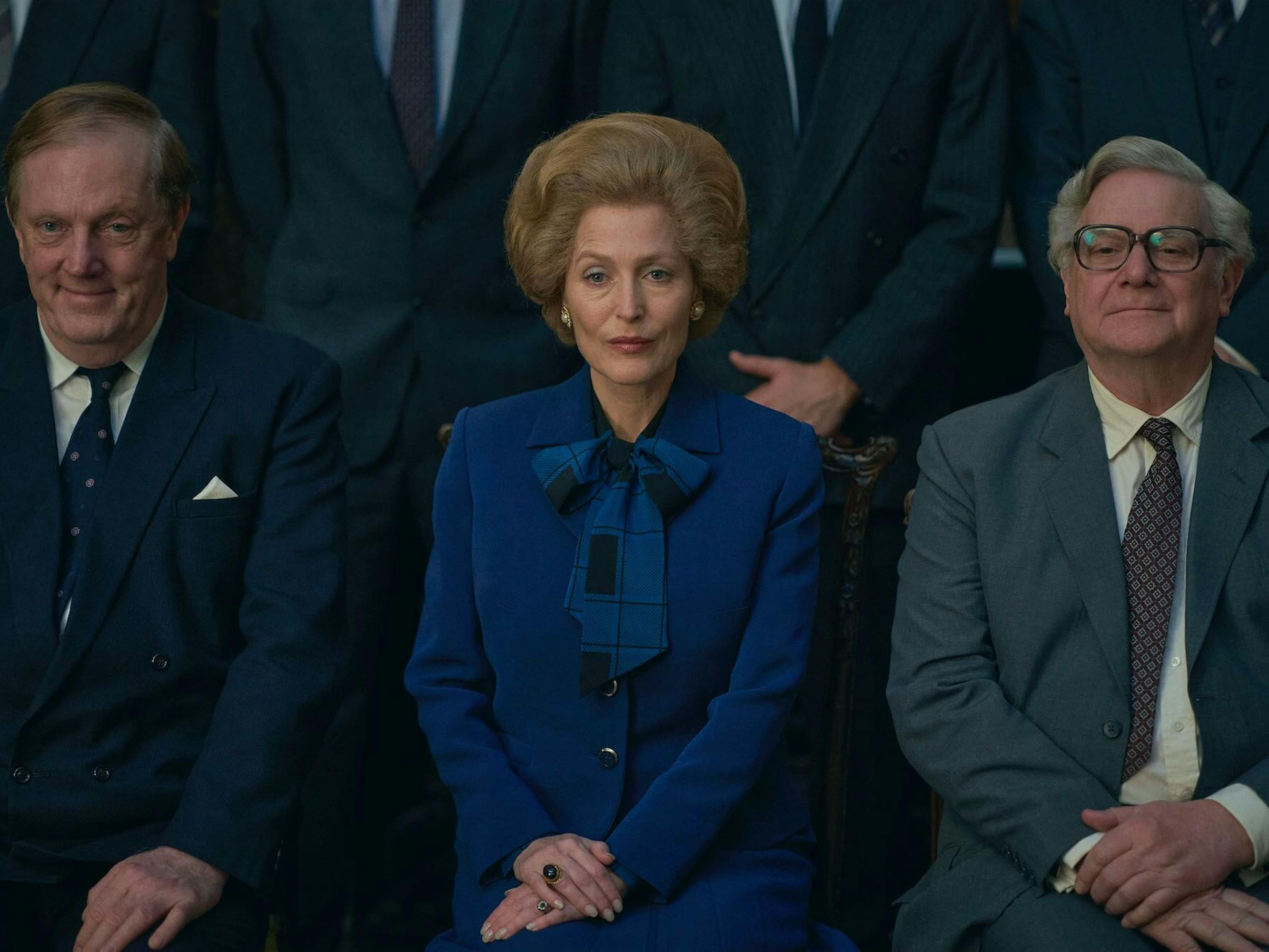 Margaret Thatcher (Gillian Anderson) and members of her cabinet sit for a picture.