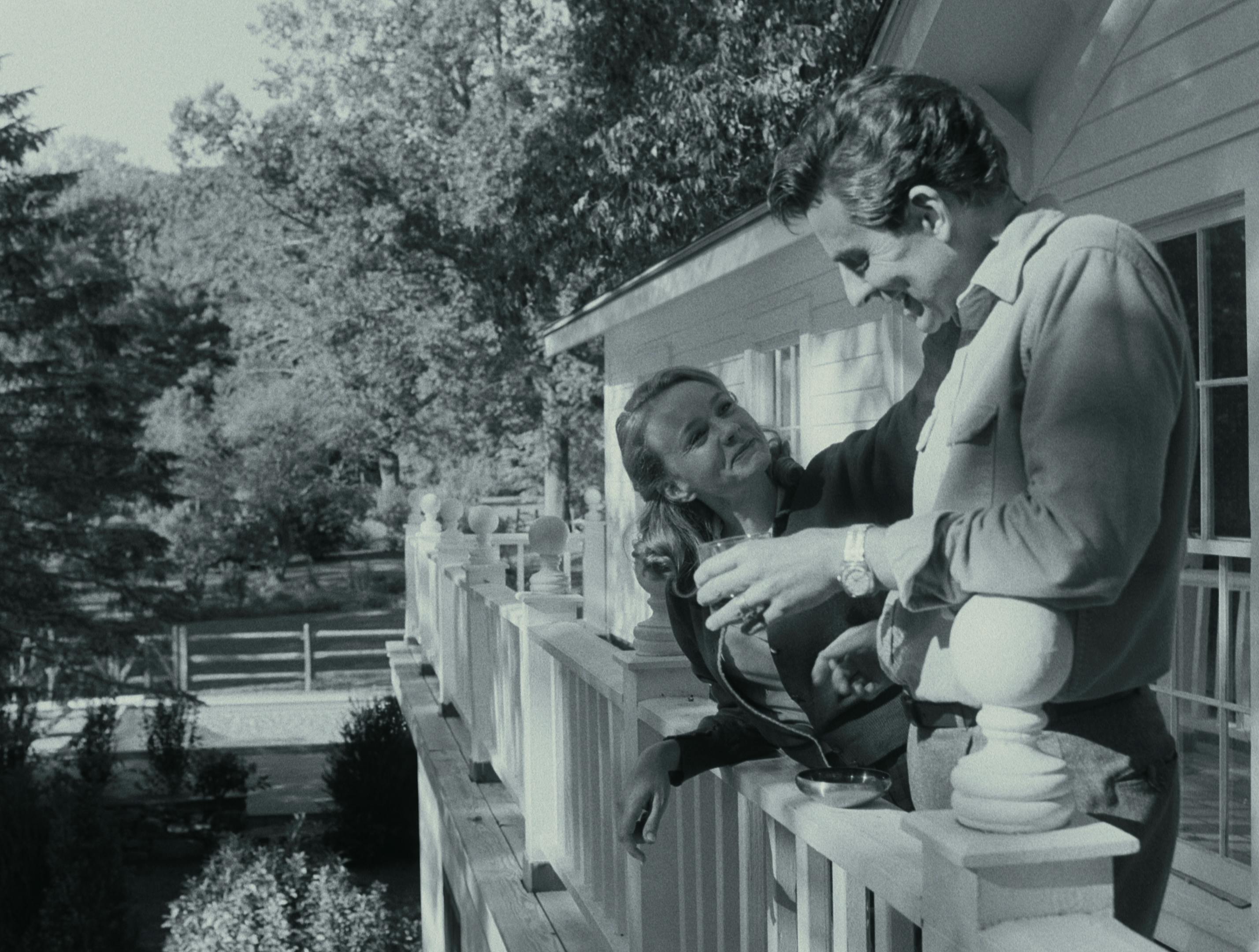 Felicia Montealegre Cohn Bernstein (Carey Mulligan) and Leonard Bernstein (Bradley Cooper) stand on a porch in this beautiful, sunny picture. 