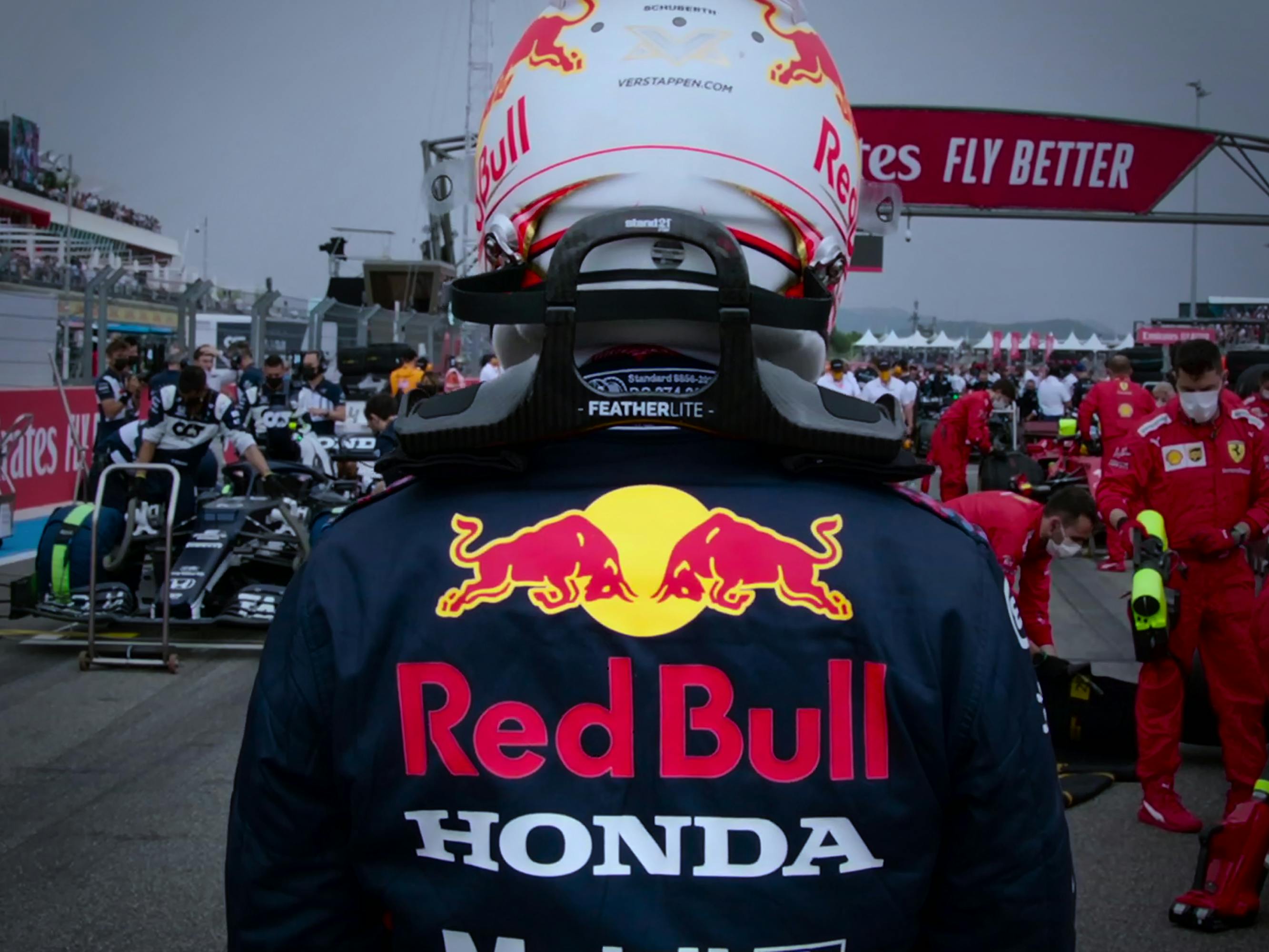 Max Verstappen wears his red bull uniform and approaches the track.