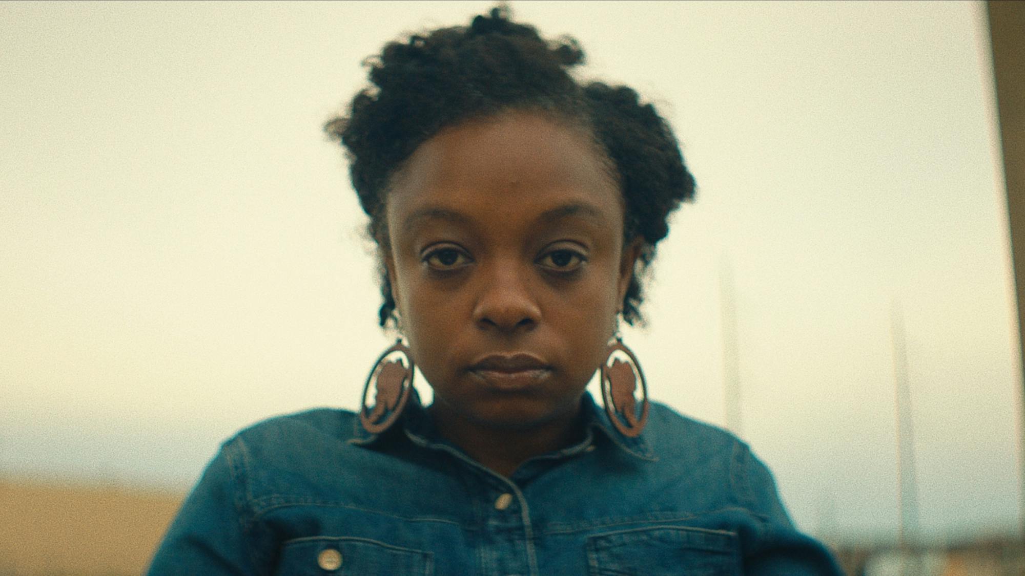 Joycelyn Davis wears a denim top and earrings.