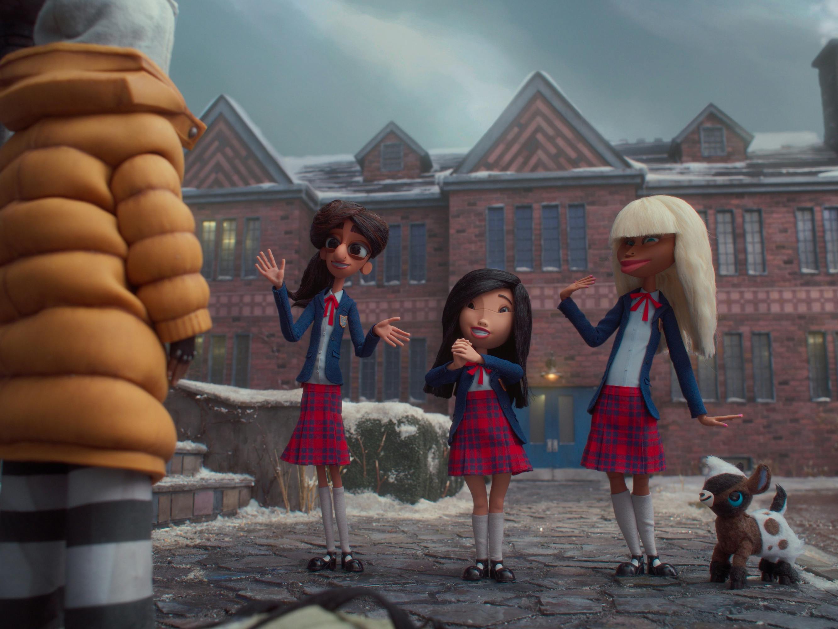 Kat (Lyric Ross), Sloane (Seema Virdi), Sweetie (Ramona Young), Siobhan (Tamara Smart), and Gabby Goat talk outside a brick house, against a cloudy sky.