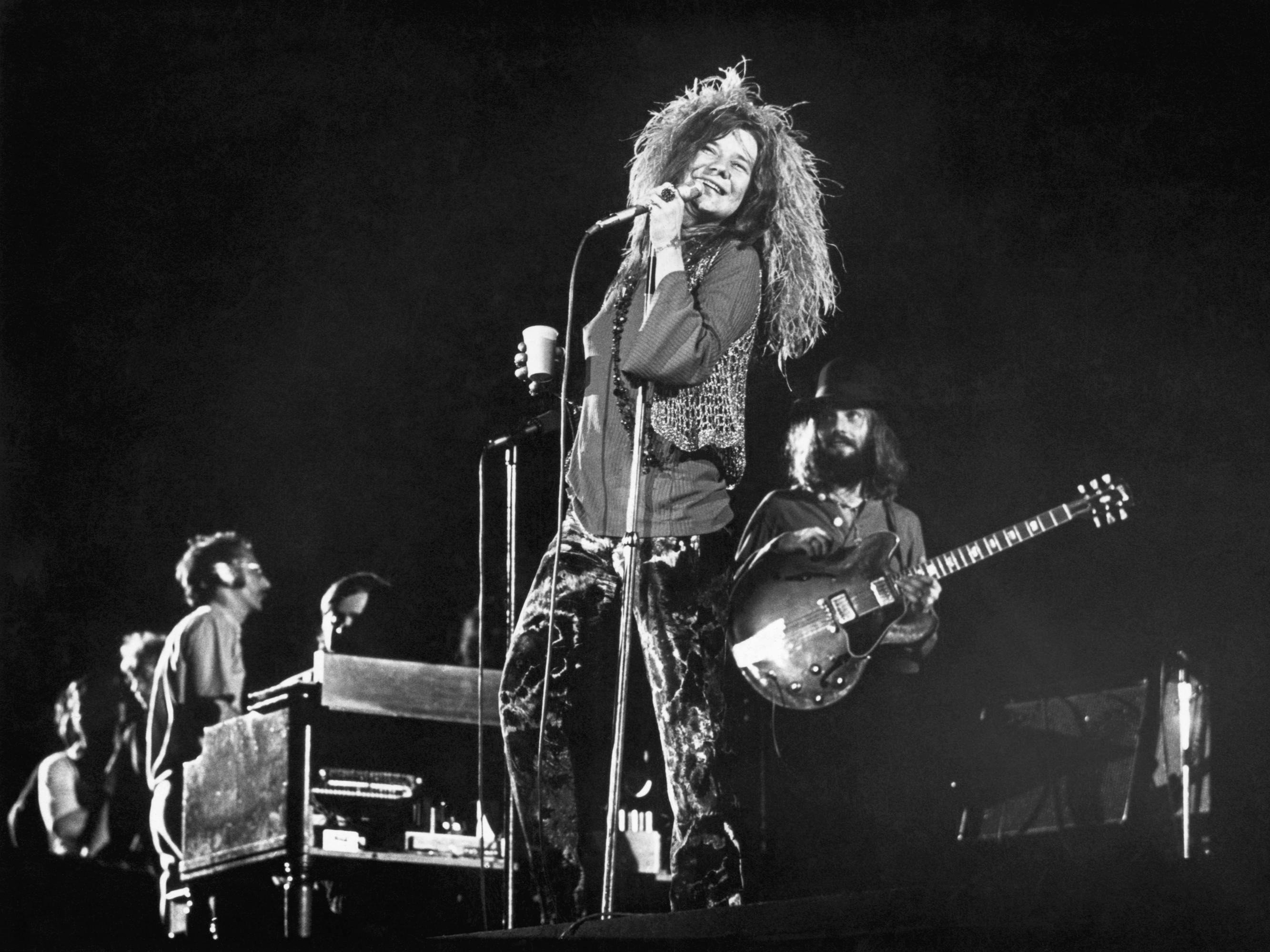 Janis Joplin sings onstage in this black-and-white shot.