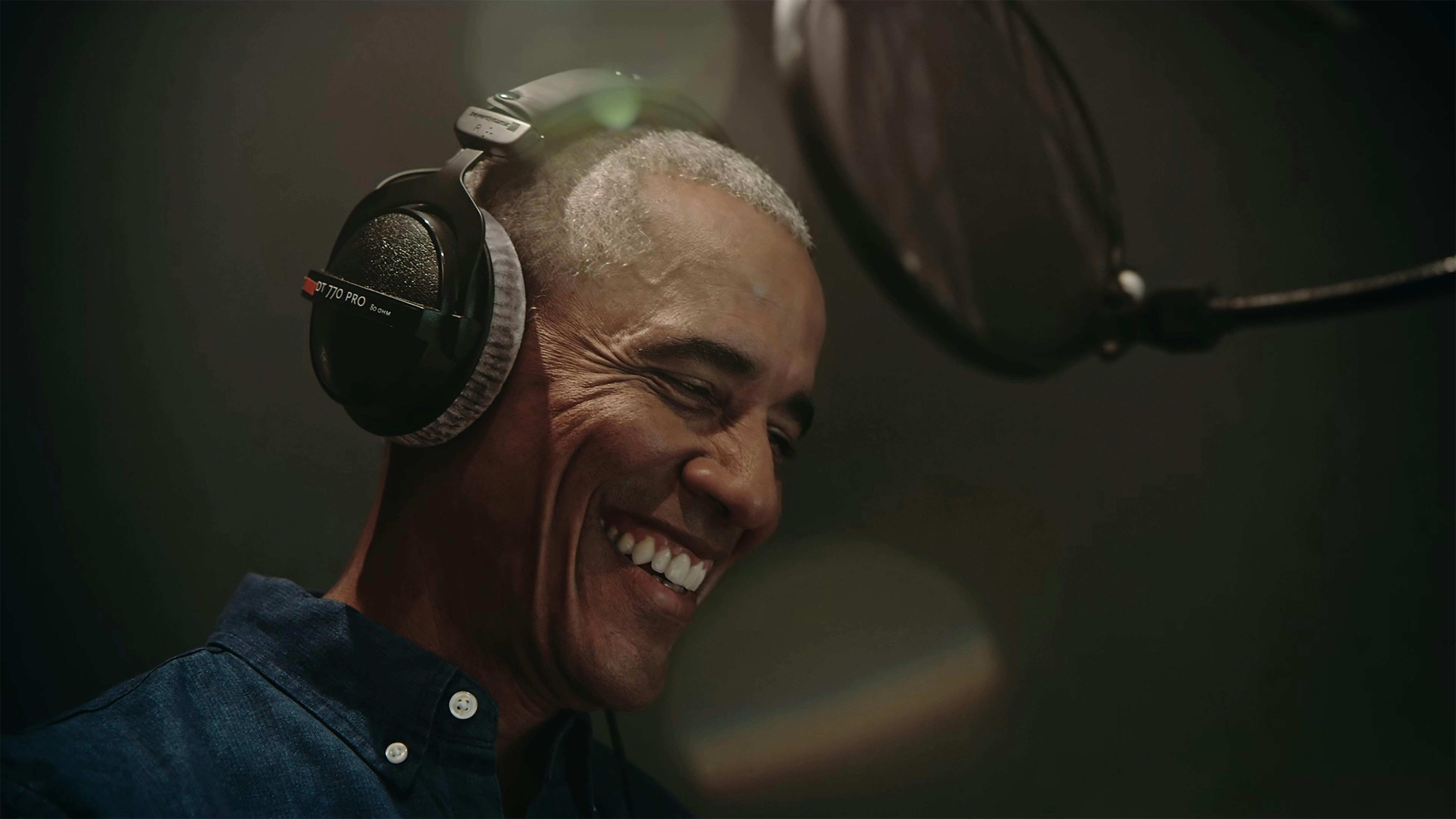 Barack Obama flashes his epic smile in a recording booth. 