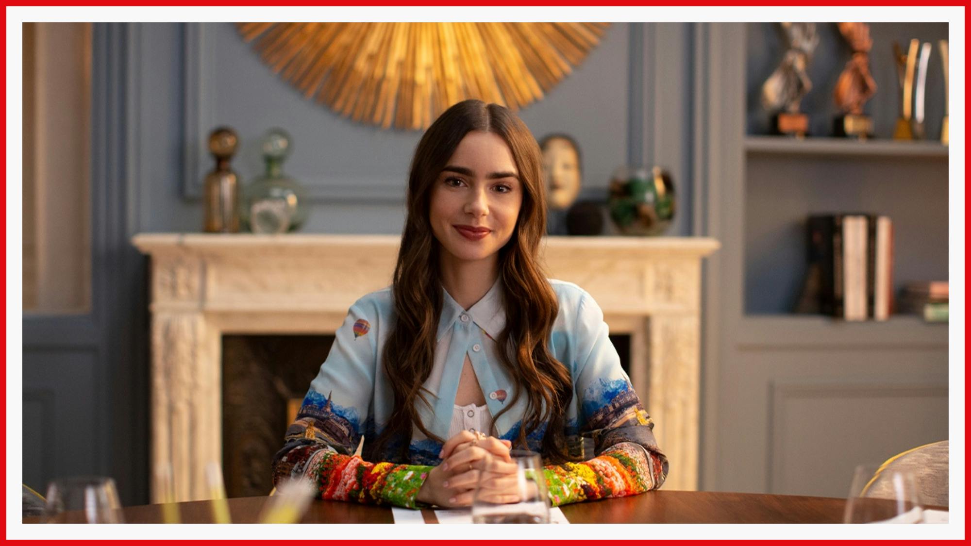 Lily Collins looks eager to impress as Emily in Emily in Paris. Her blue blouse matches the room.