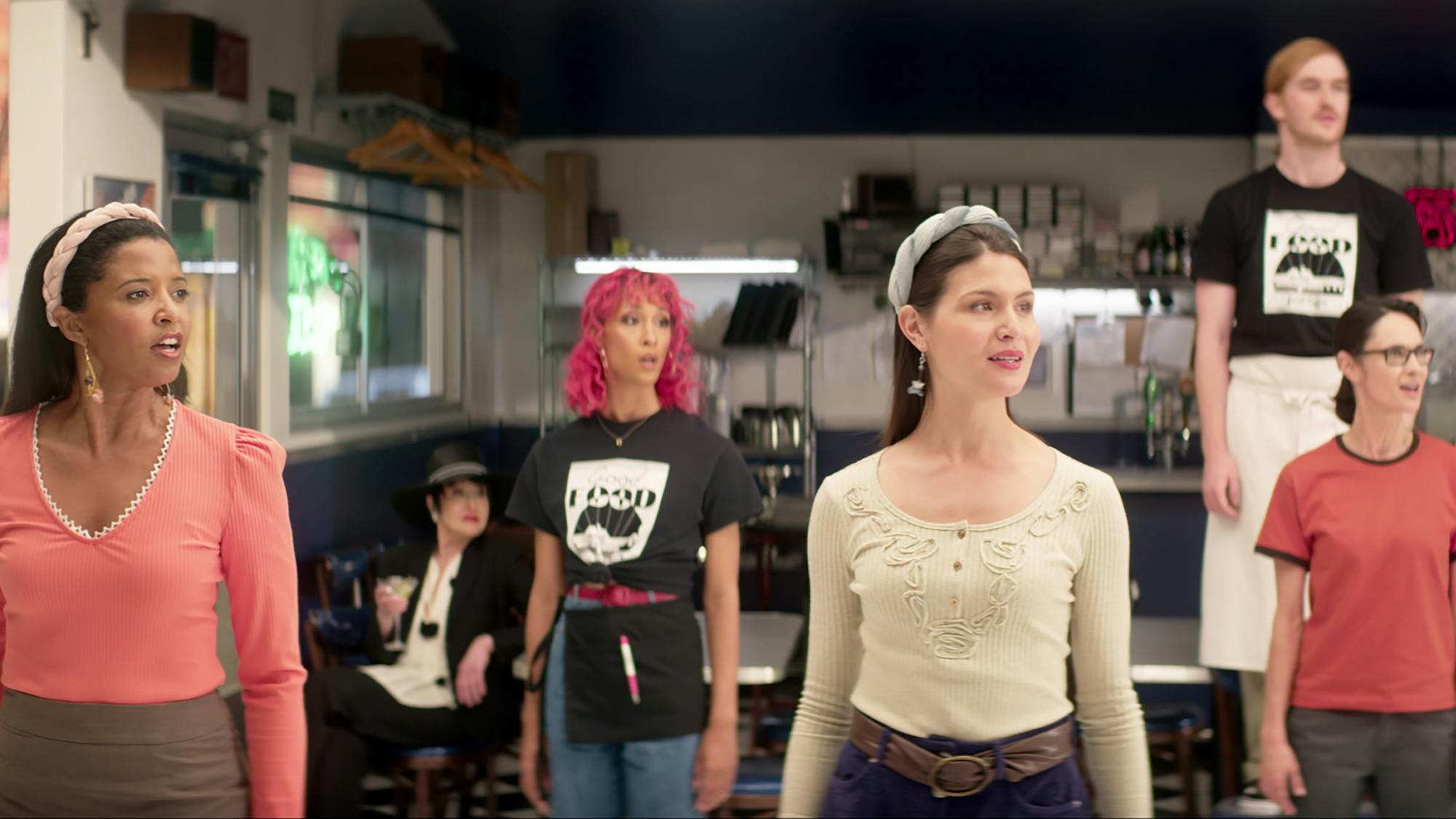 Renée Elise Goldsberry, Mj Rodriguez, Phillipa Soo, and Beth Malone stand outside the Moondance Diner in unison.