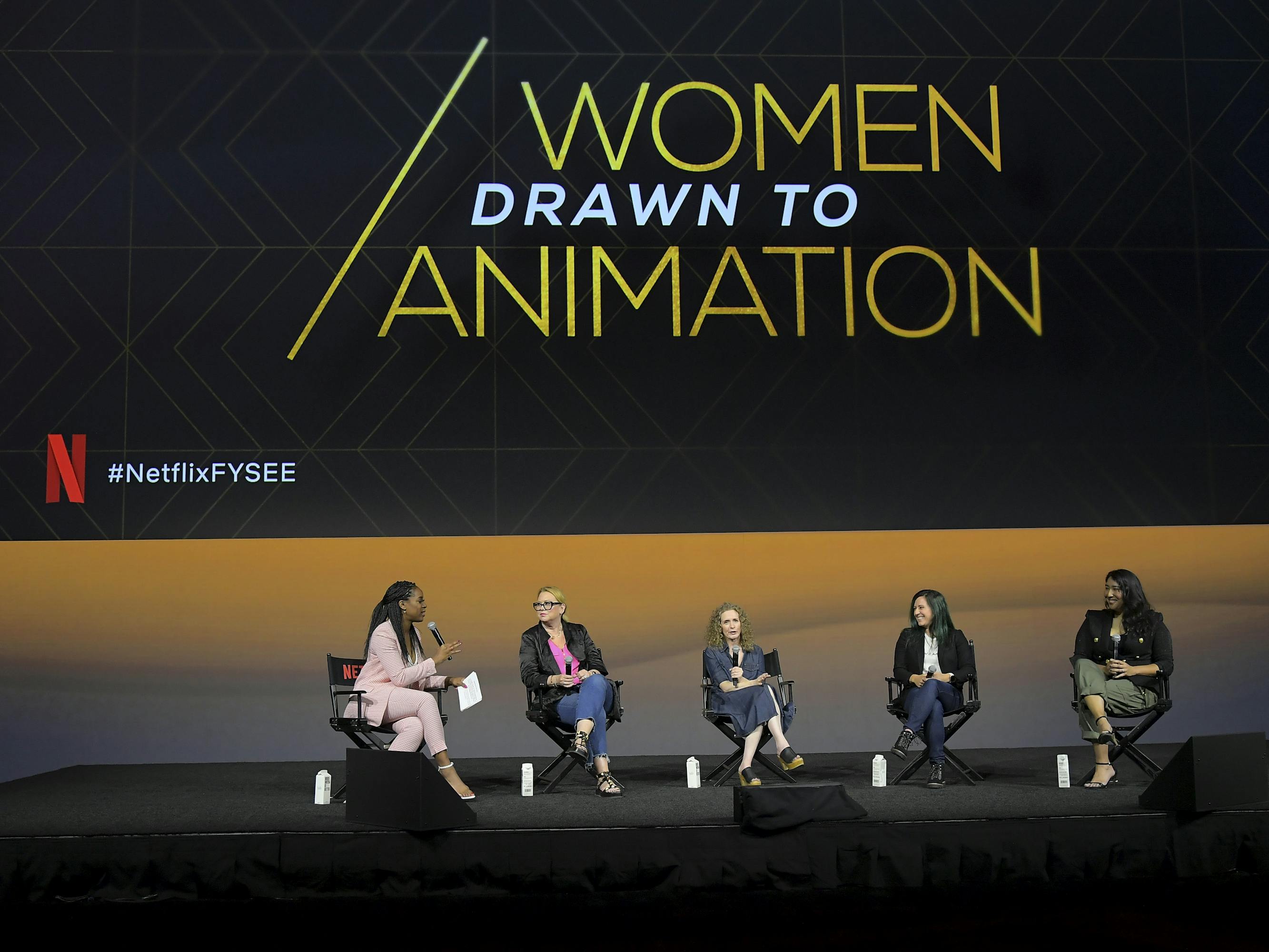 Janine Rubenstein, Melinda Dilger (Arcane), Jennifer Flackett (Big Mouth and Human Resources), Kelly Galuska (Human Resources), and Emily Dean (Love, Death + Robots) sit onstage against a screen that reads "Women Drawn to Animation."