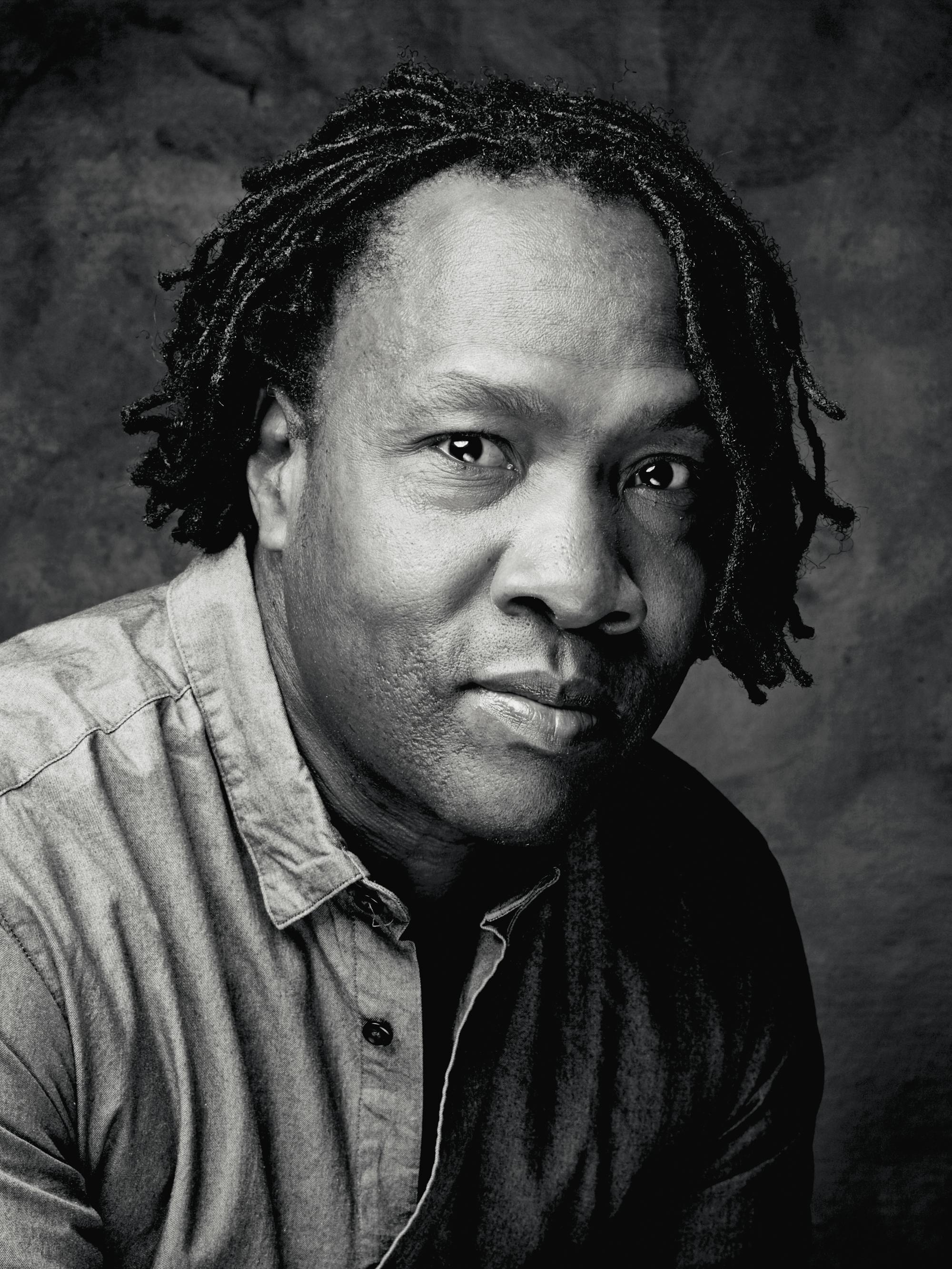 Roger Ross William wears a button-down shirt.