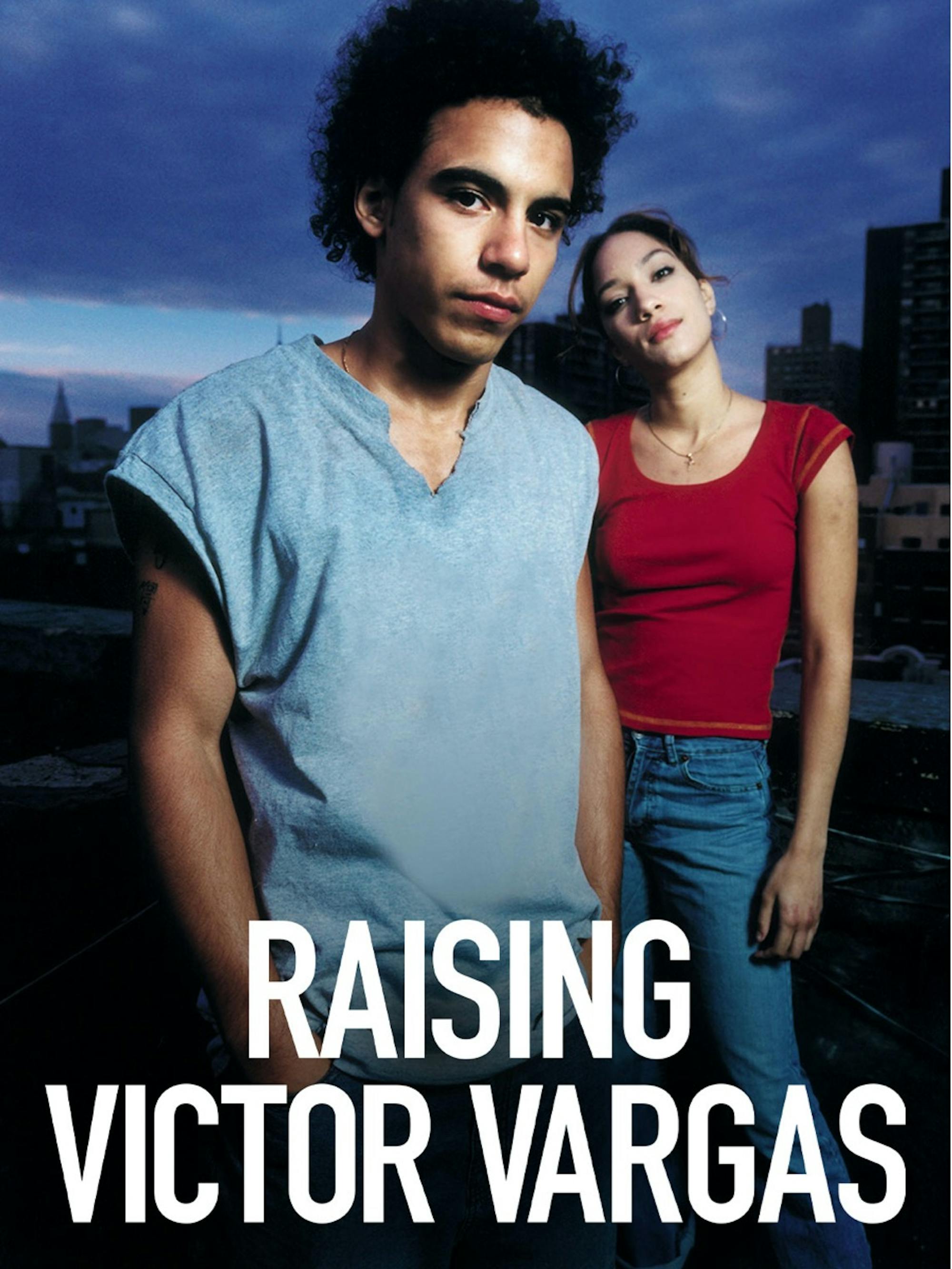 A poster for Raising Victor Vargas. Victor Rasuk wears a blue tank top. The woman behind him wears a red shirt and jeans. The sky is dark and stormy, and they seem to be standing on a roof.
