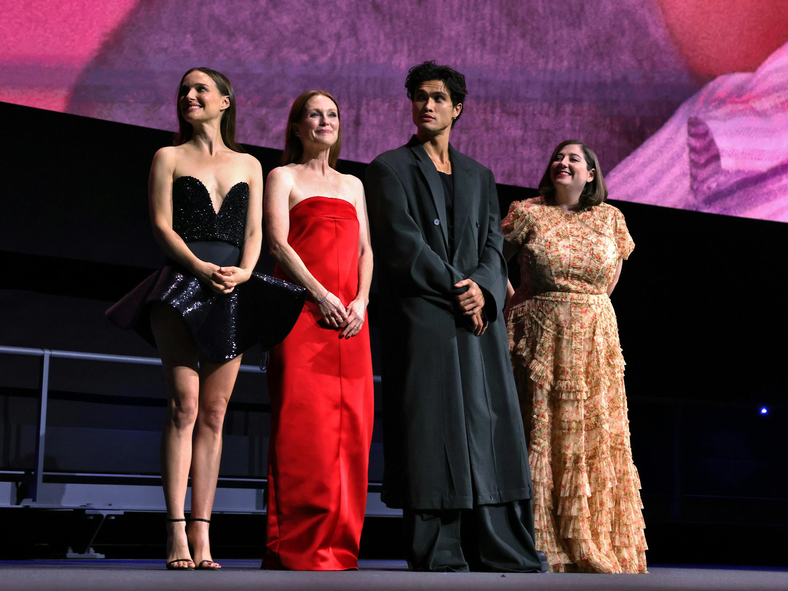 Natalie Portman, Julianne Moore, Charles Melton, and Samy Burch stand on stage.