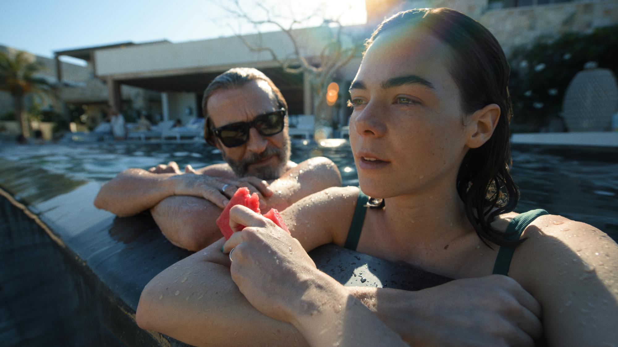 Daniel Giménez Cacho and Ximena Lamadrid sit in a pool together.