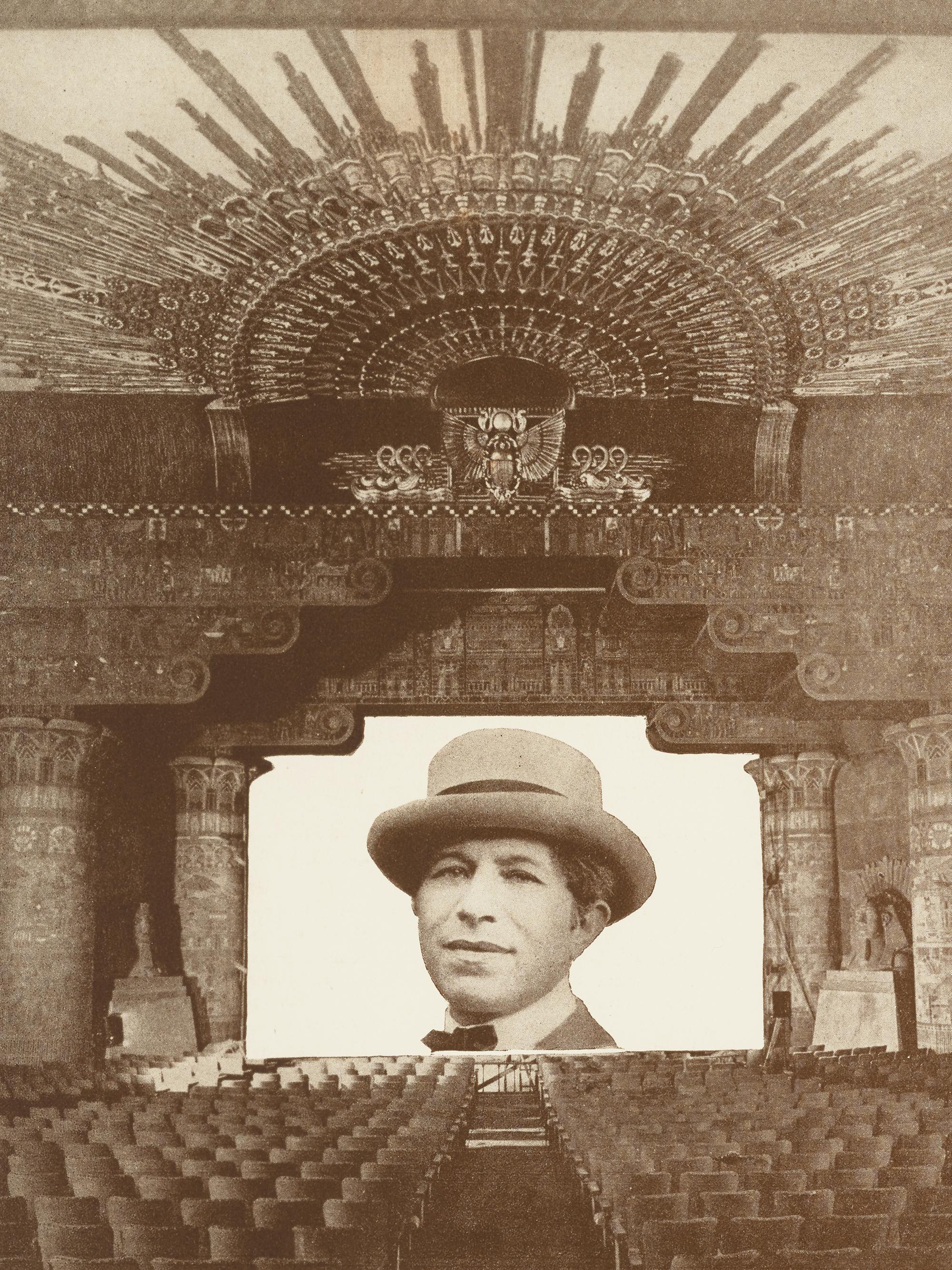 A picture of Sid Grauman on a screen in an empty theater. 