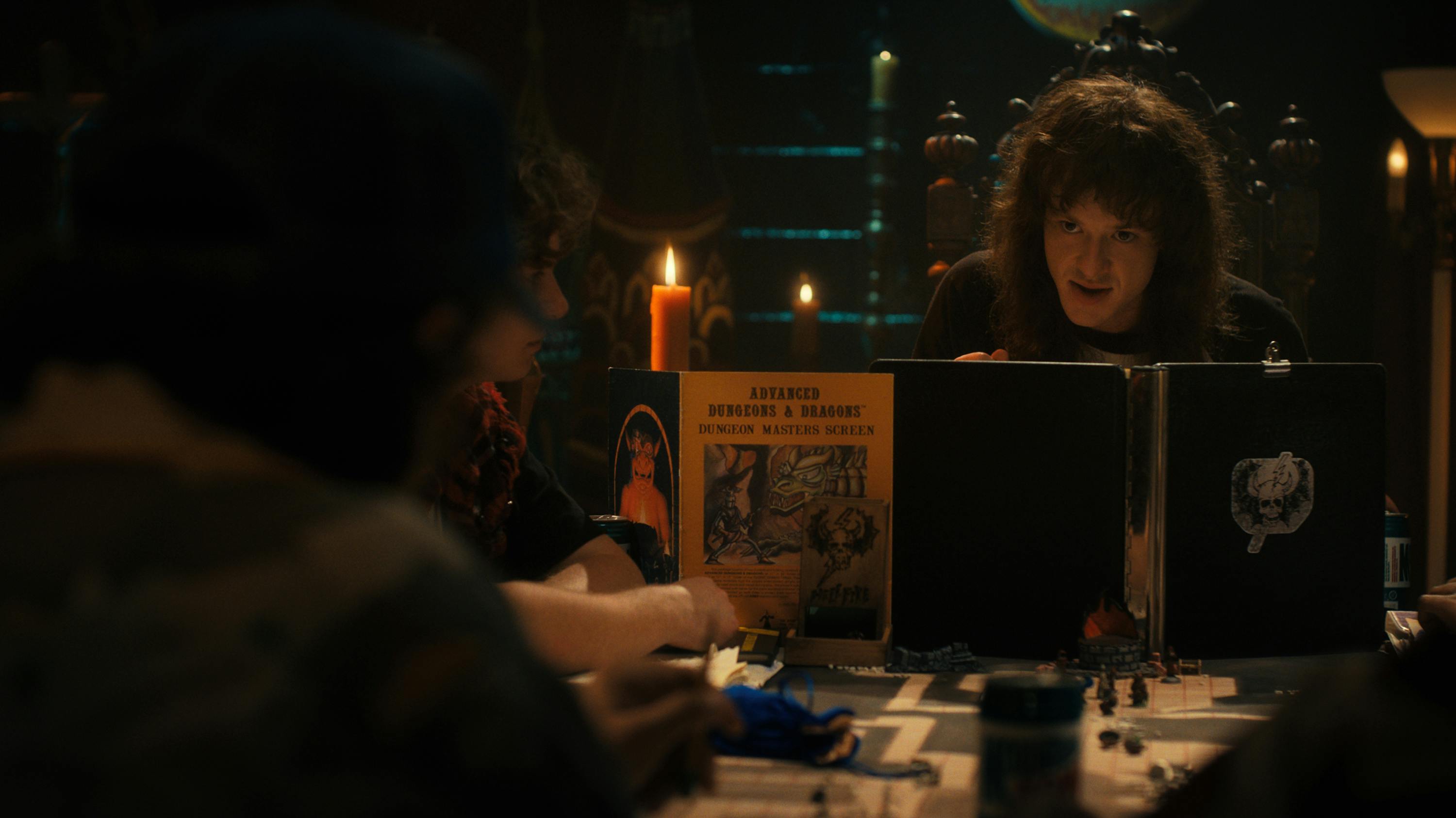 Eddie Munson (Joseph Quinn) plays Dungeons and Dragons by candlelight.
