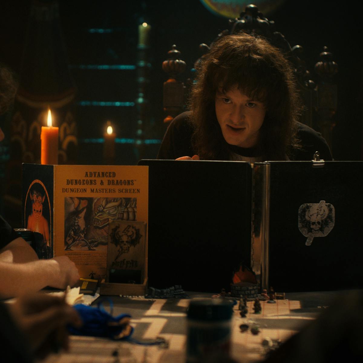 Eddie Munson (Joseph Quinn) plays Dungeons and Dragons by candlelight.