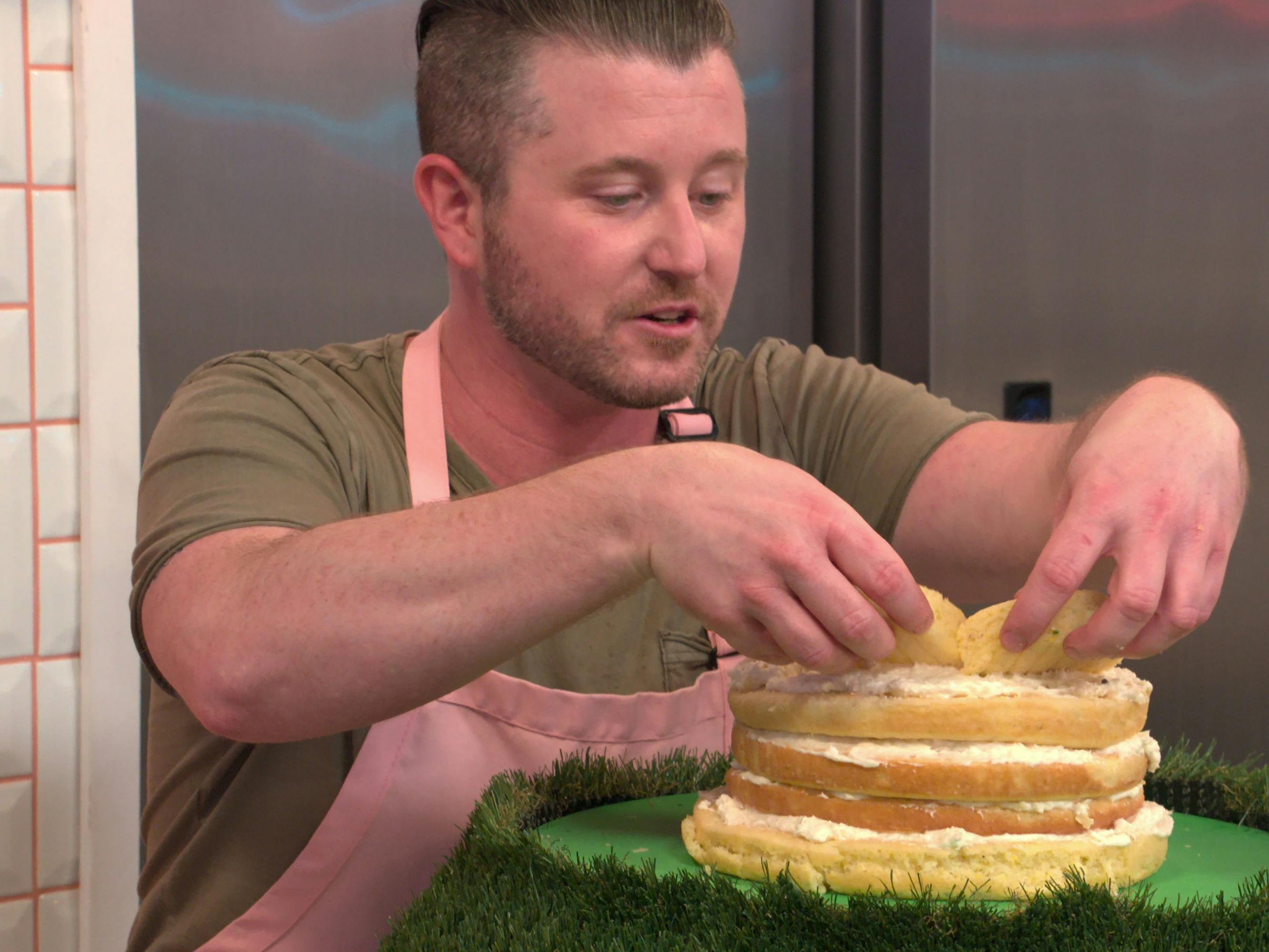 A contestant from Nailed It! makes an intricate layered cake. 