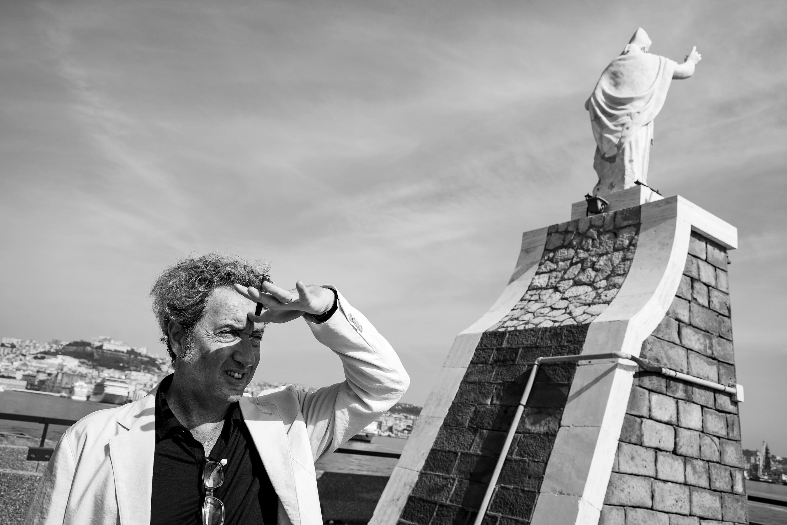 Paolo Sorrentino shades his eyes in this black and white photo.