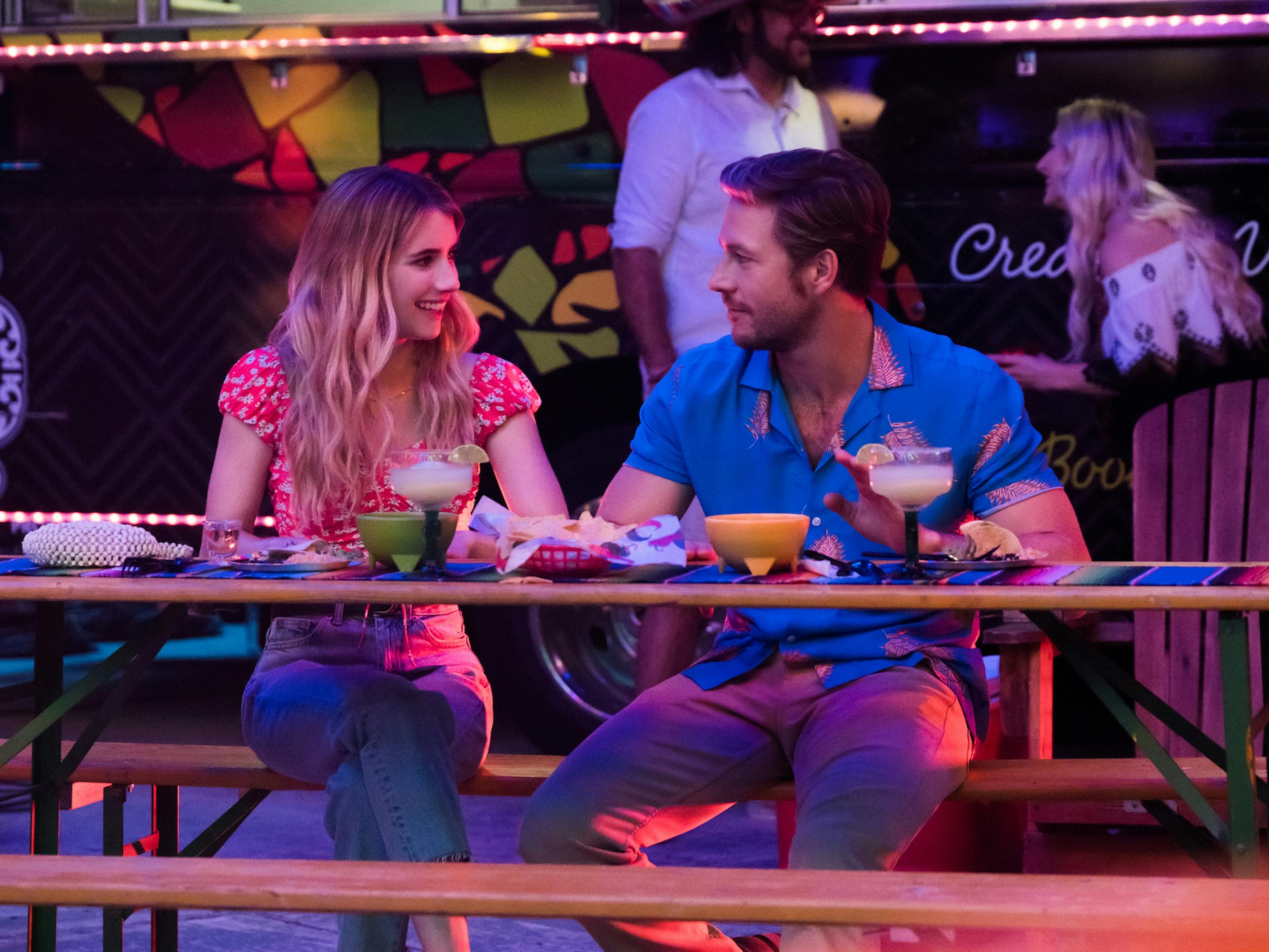 Sloane (Emma Roberts) and Jackson (Like Bracey) sit at a picnic table together.