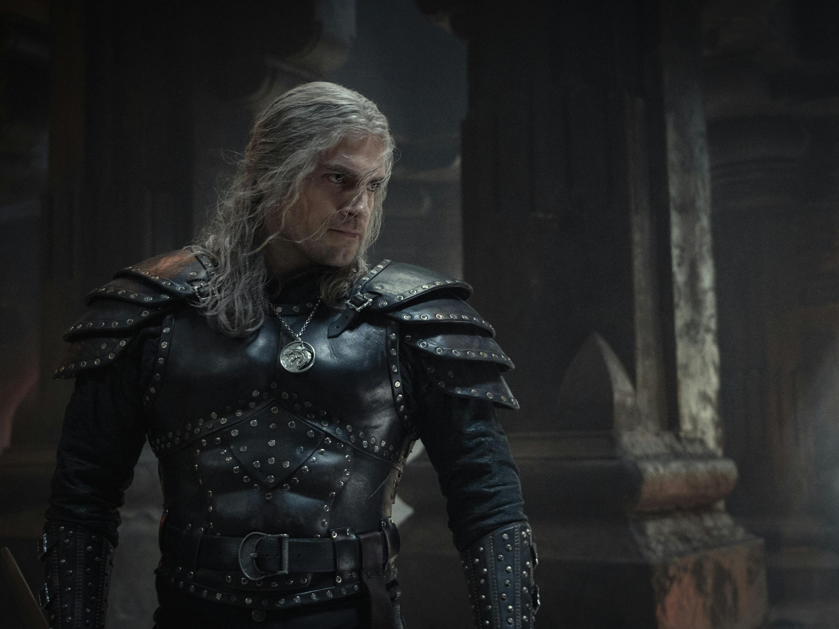 Geralt of Rivia wears black armour and has long grey hair.