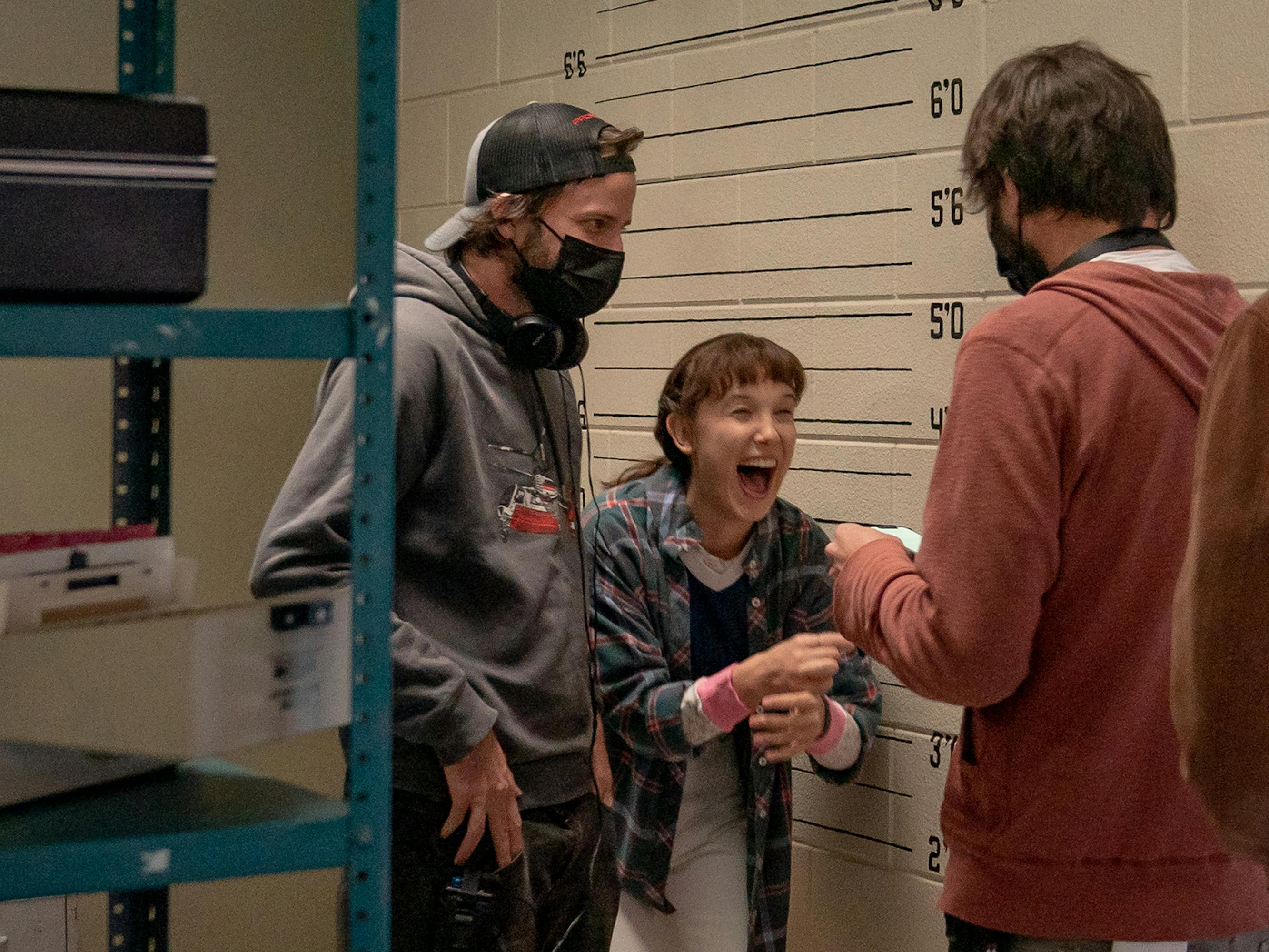 Matt Duffer, Millie Bobby Brown, and Ross Duffer share a joke backstage.