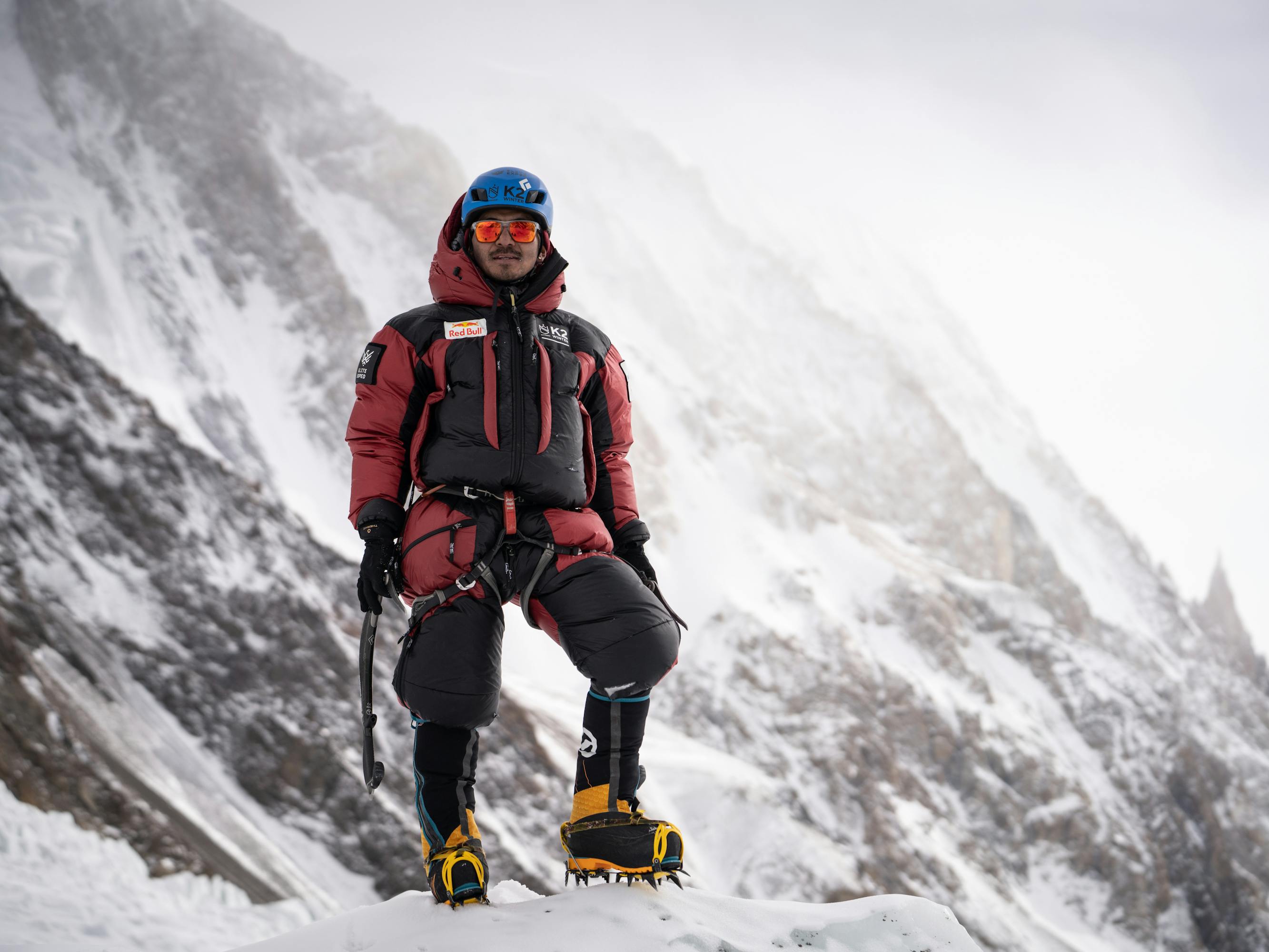 Mingma David Sherpa wears a red and black outfit against a foggy background.